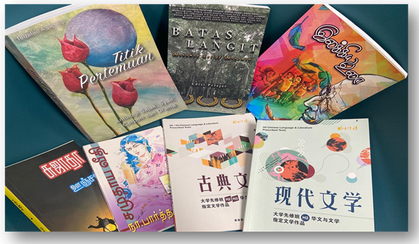 Several books in Malay, Tamil, and Chinese spread on a teal surface, including titles like Titik Pertemuan and Batas Langit.