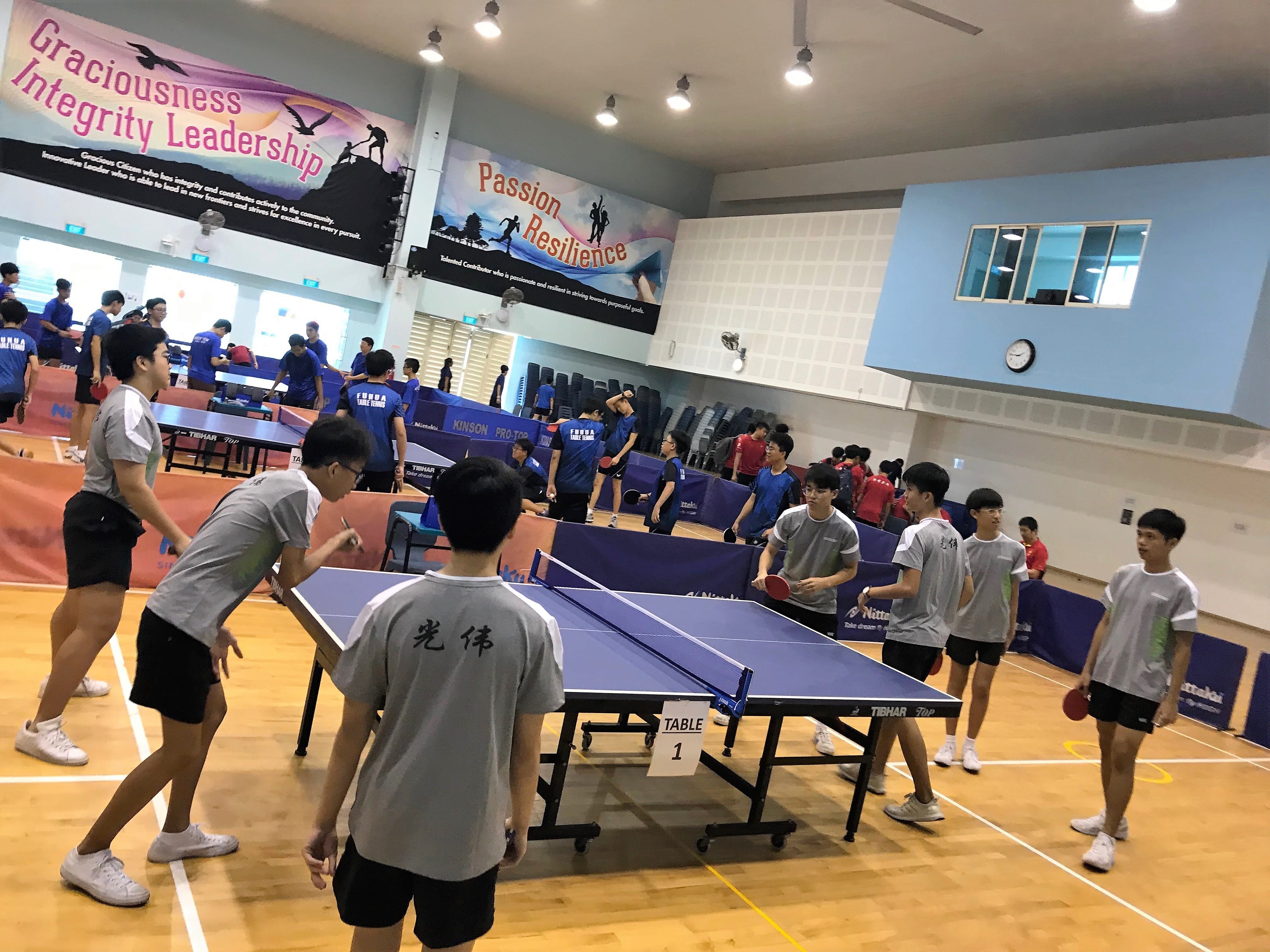 The table tennis club members playing in a tournament.