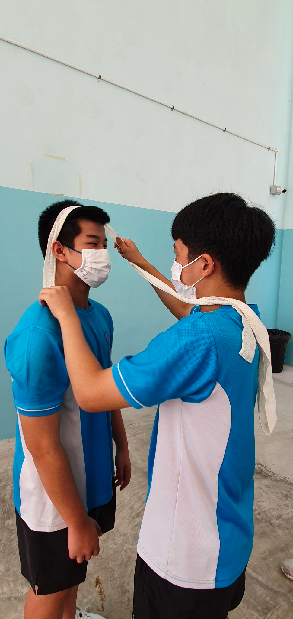 Students using each other to practice bandaging and other first aid skills.