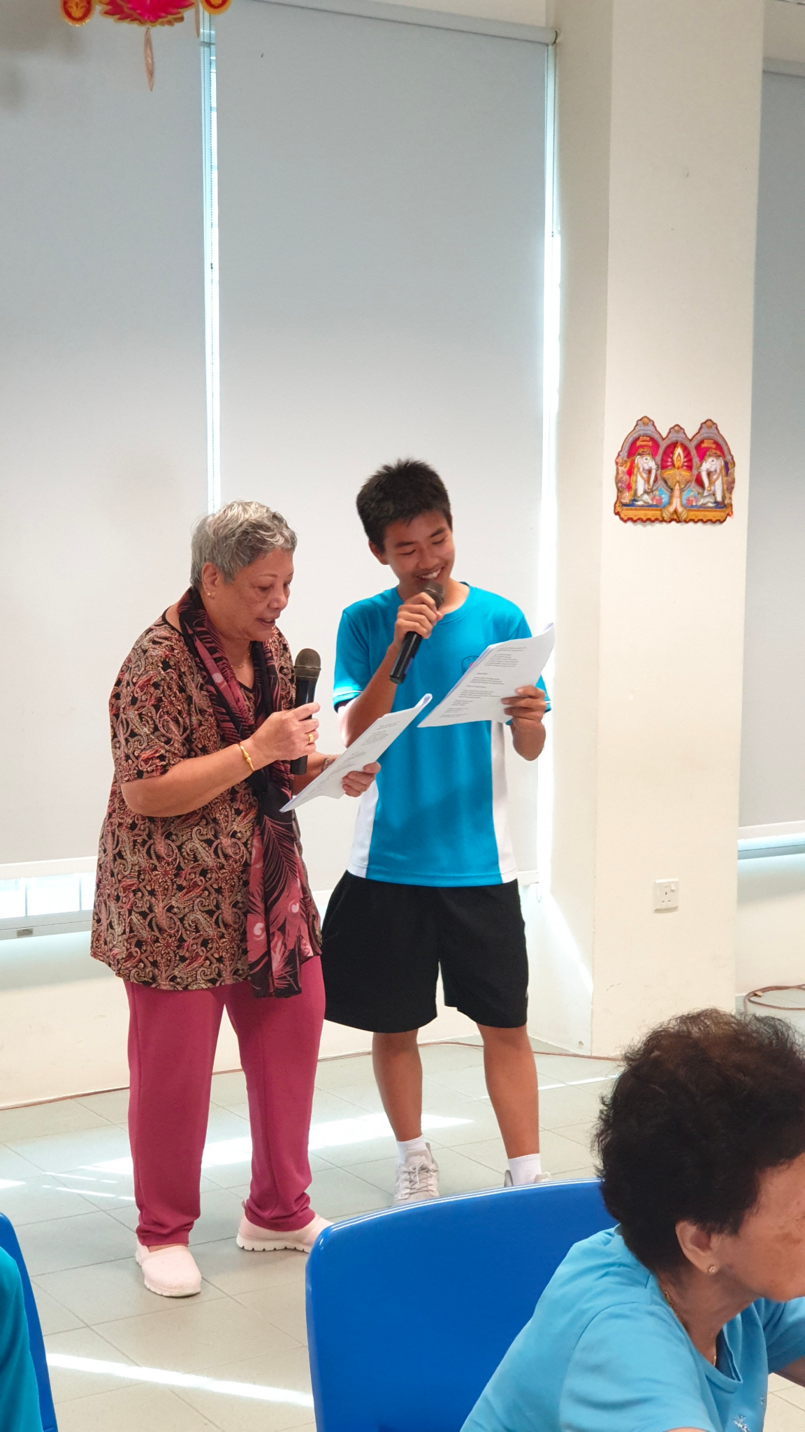 A student engaging an elder as part of outreach and community involvement efforts.