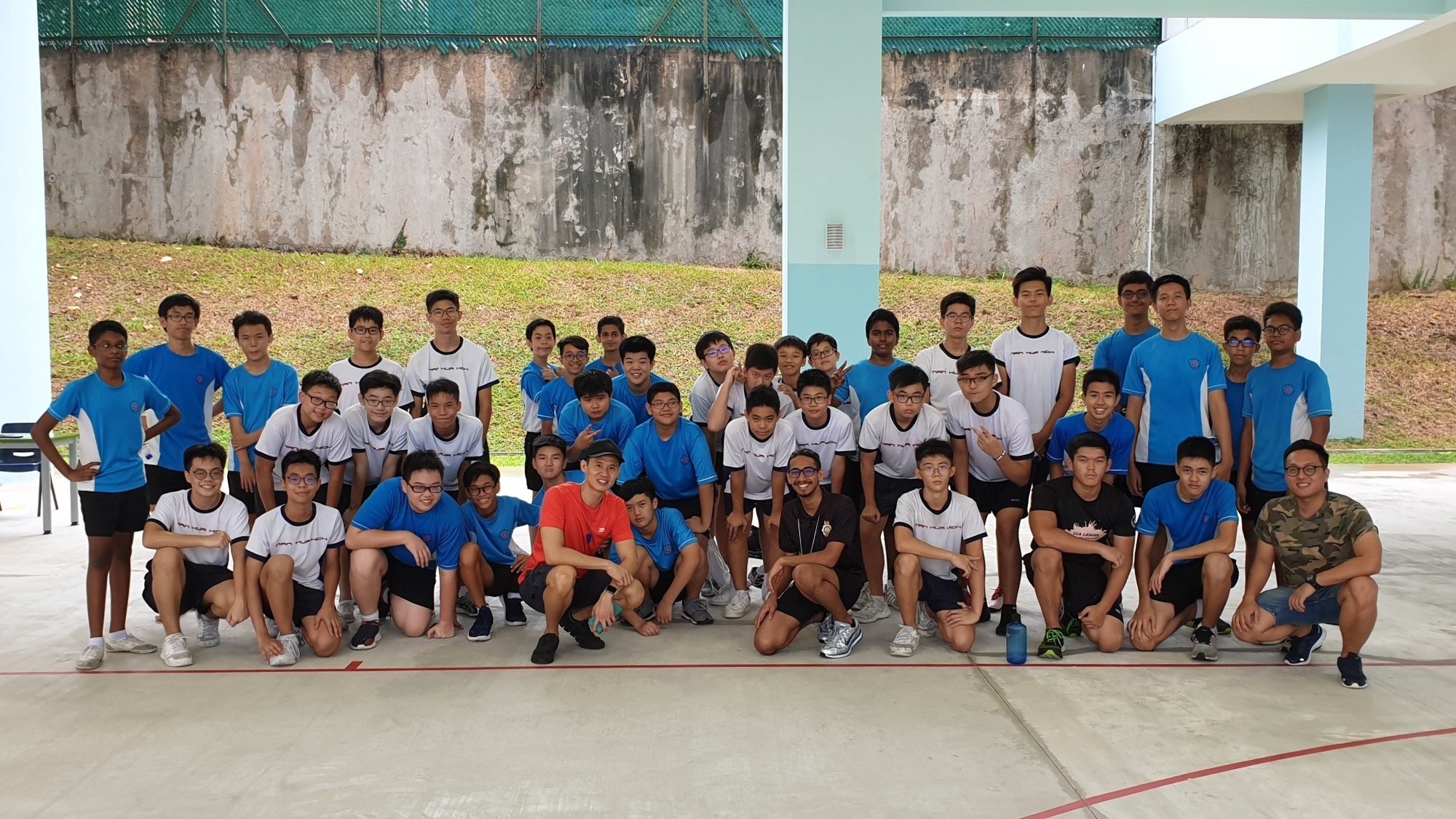 NCC CCA team photo where the students pose with the teachers and instructors at the basketball court.