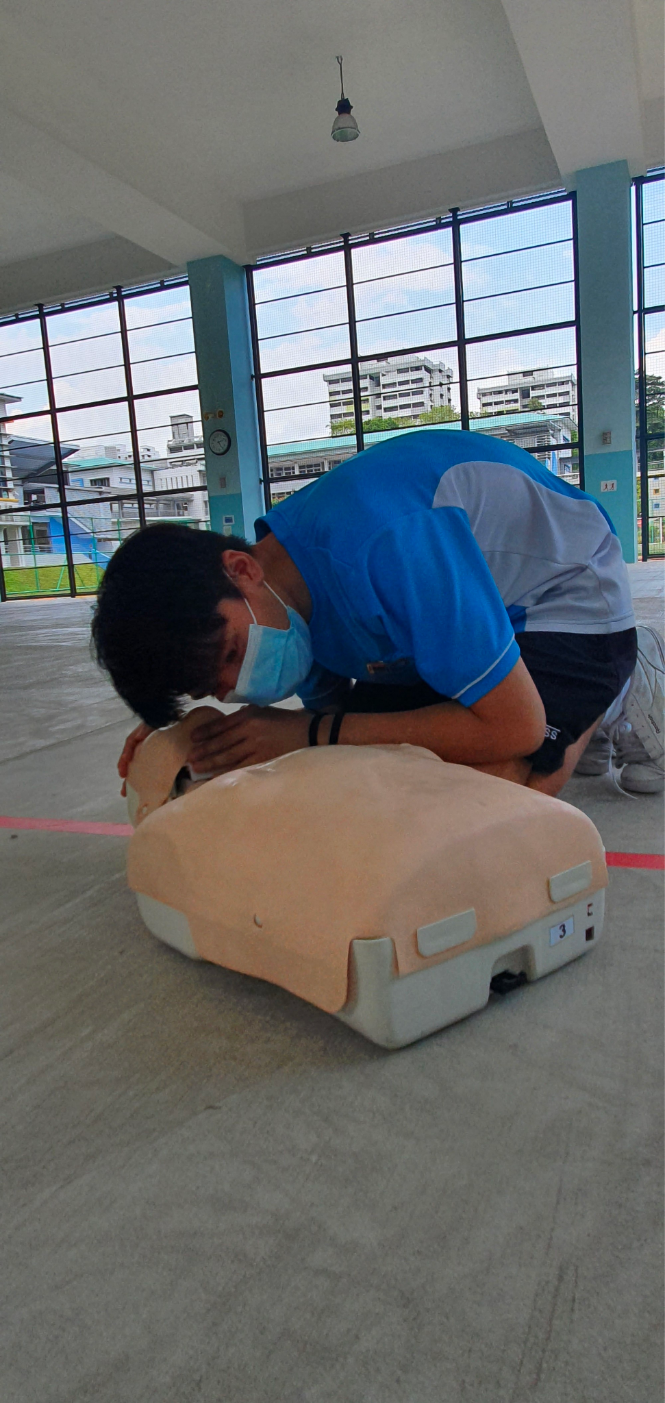 NCC member using a dummy model to practice their CPR skills.