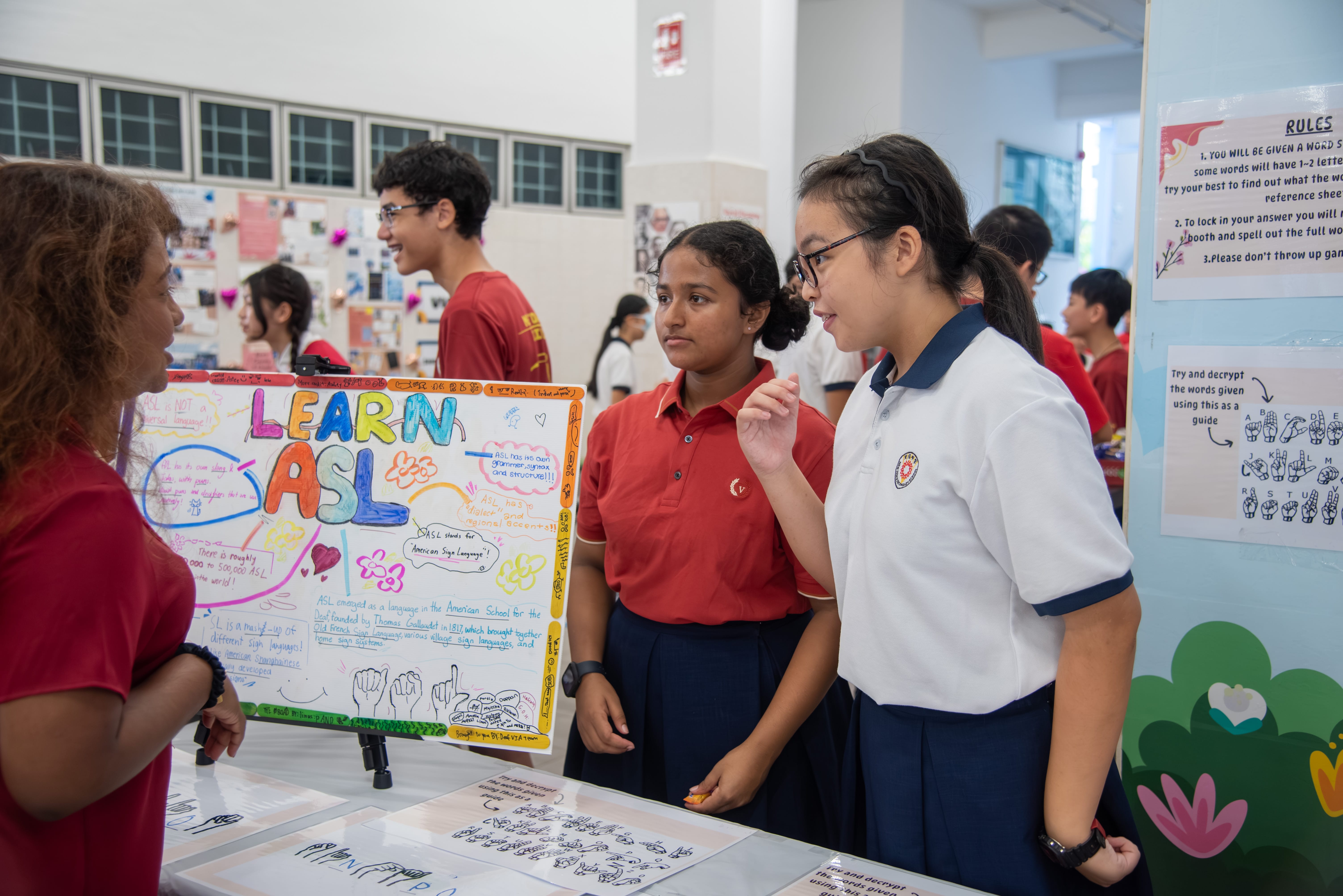Students at their VIA booth, raising awareness on sign language as part of their efforts to spread inclusivity.