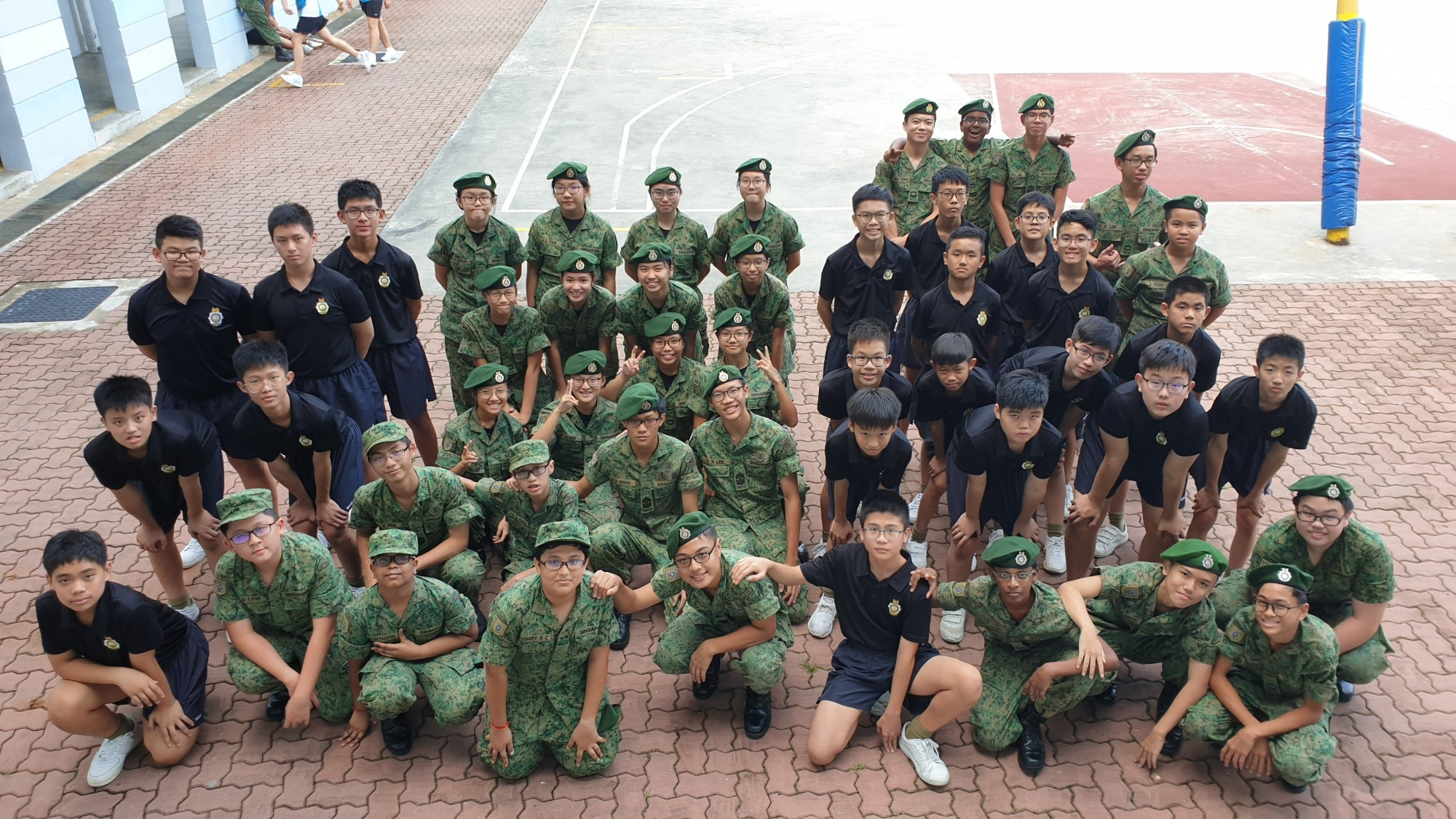 Group photo of NCC CCA of the students in their army green uniforms.
