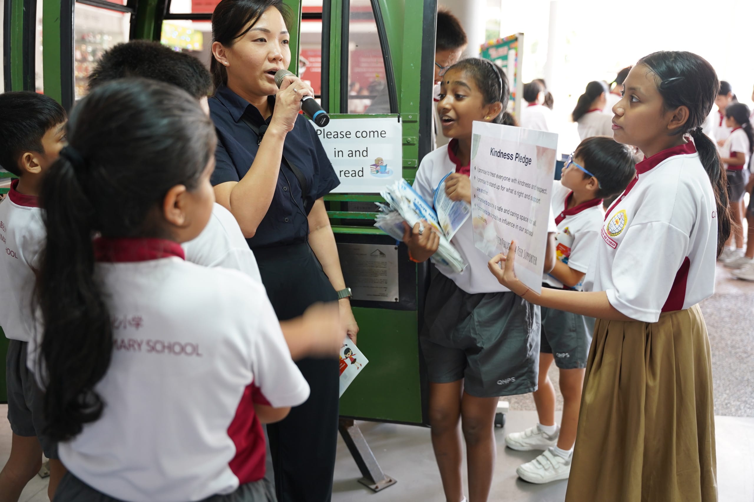 Teacher and students promoting kindness movement