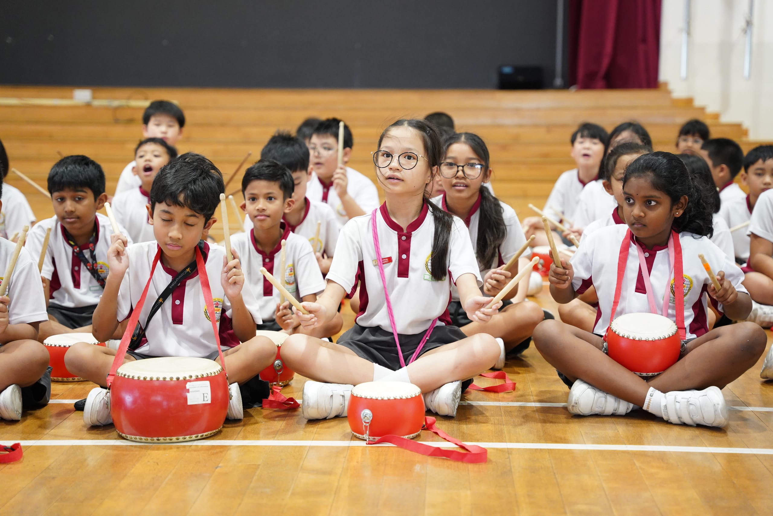 Students playing the chinese drums in the school hall