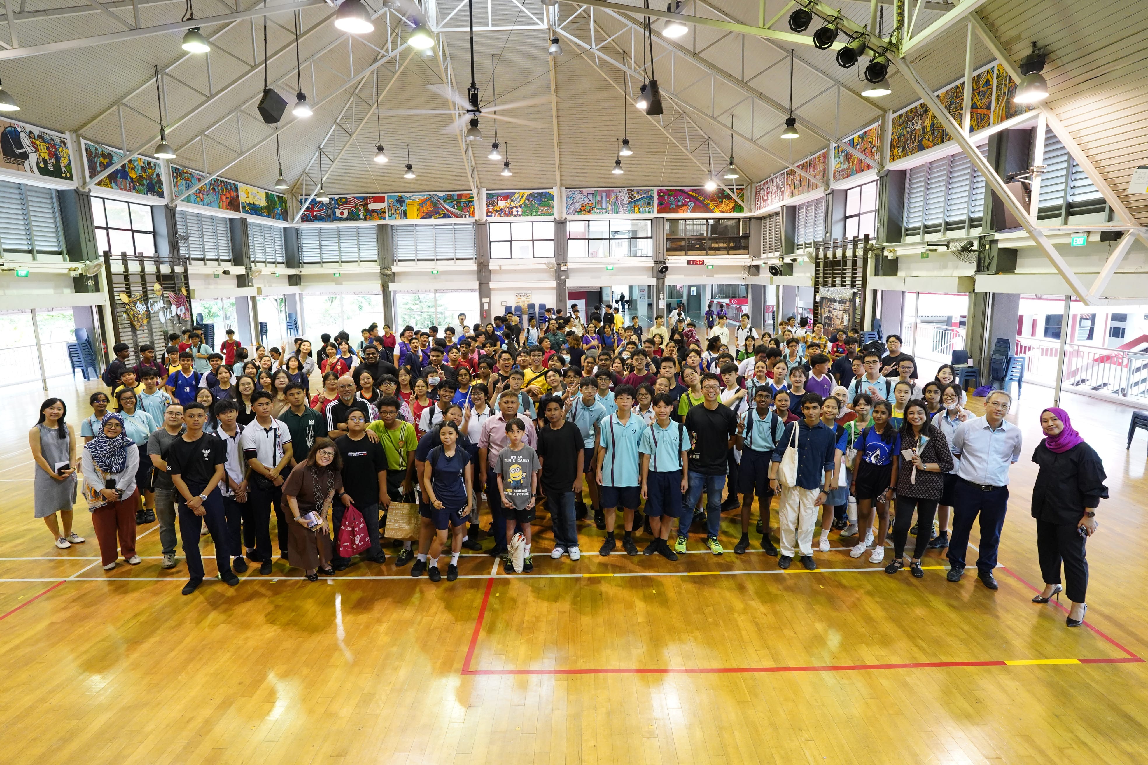 A group photo of a large number of people in the school hall