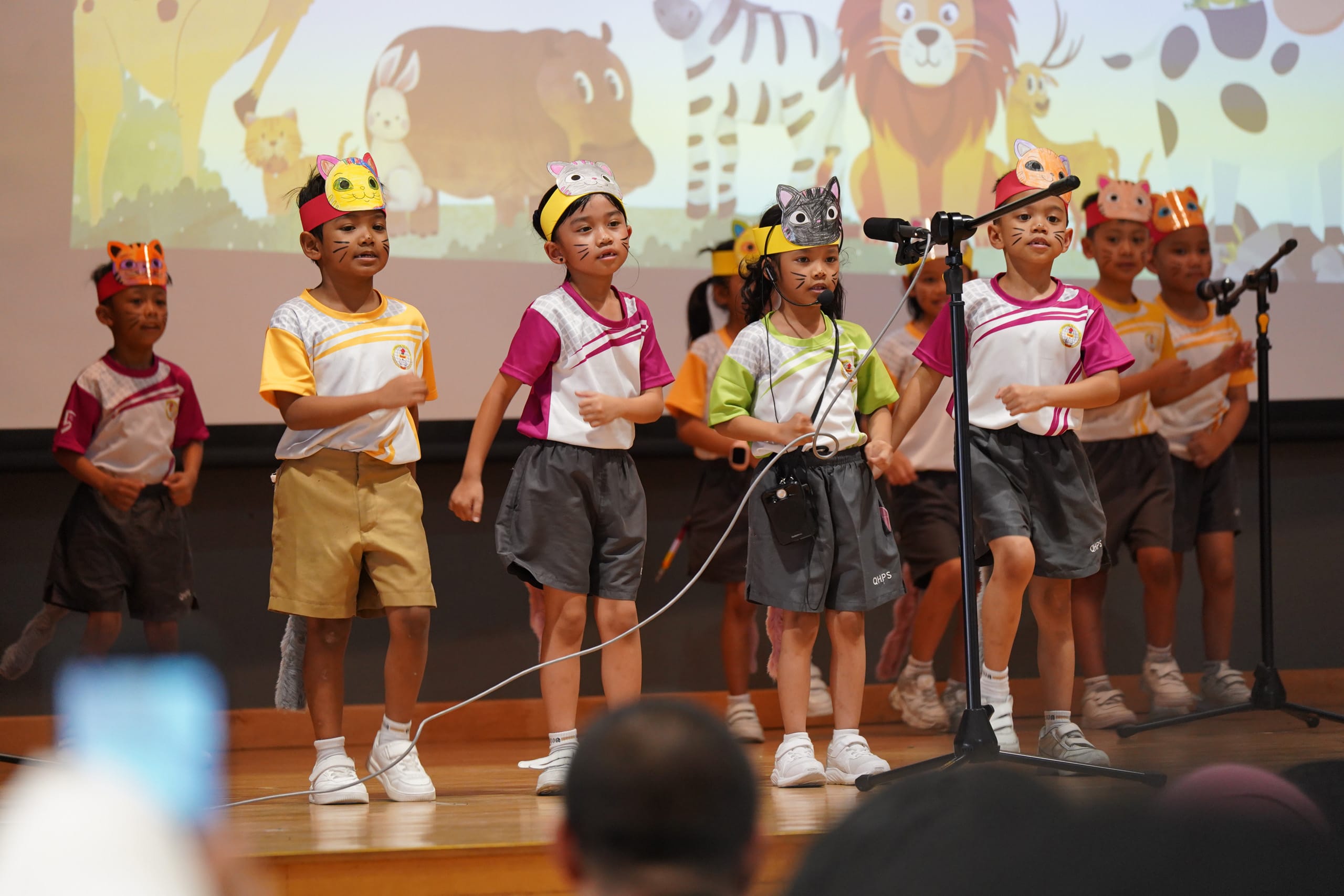 Students wearing animal mask performing on stage