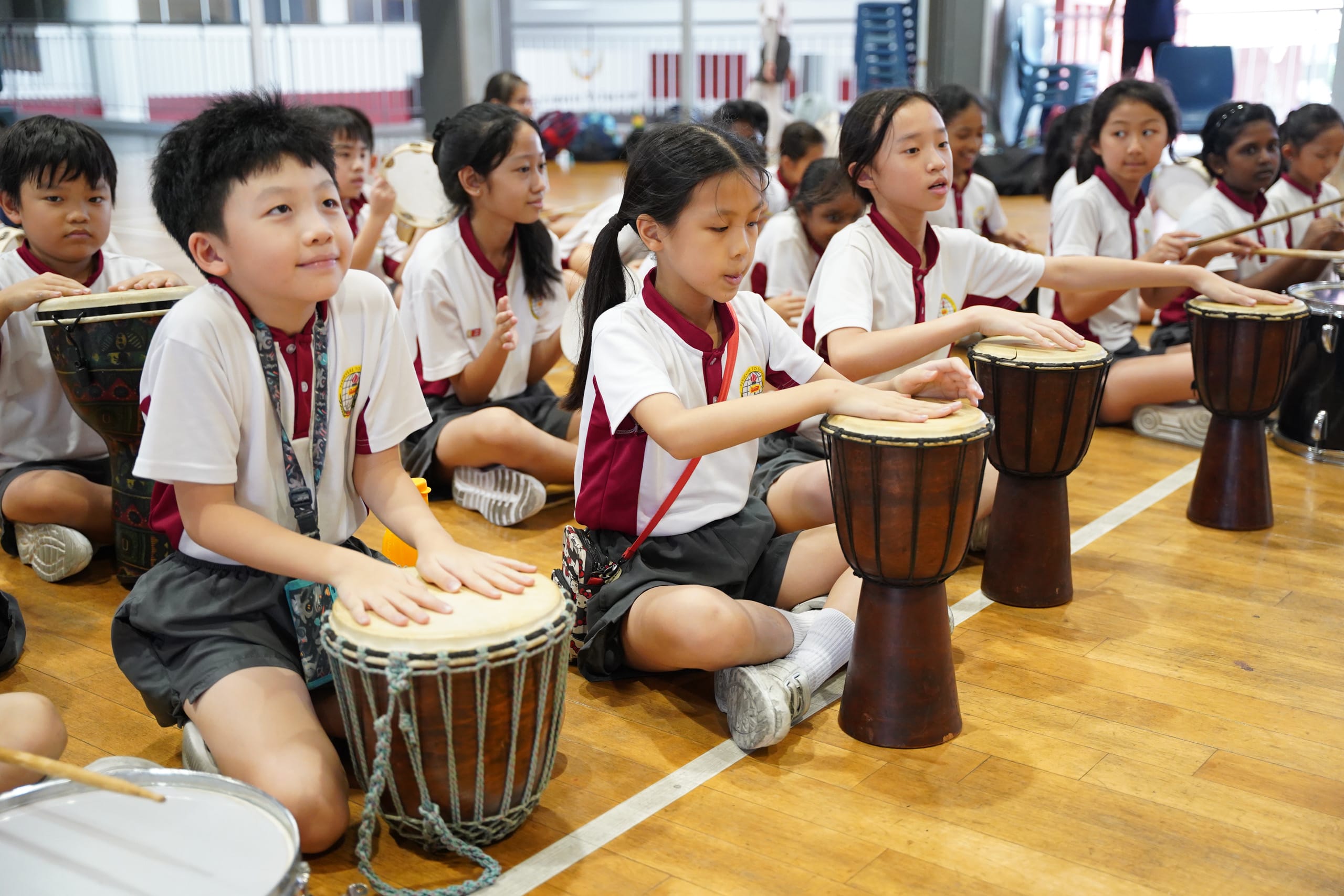 Students playing the Indian drums in the school hall