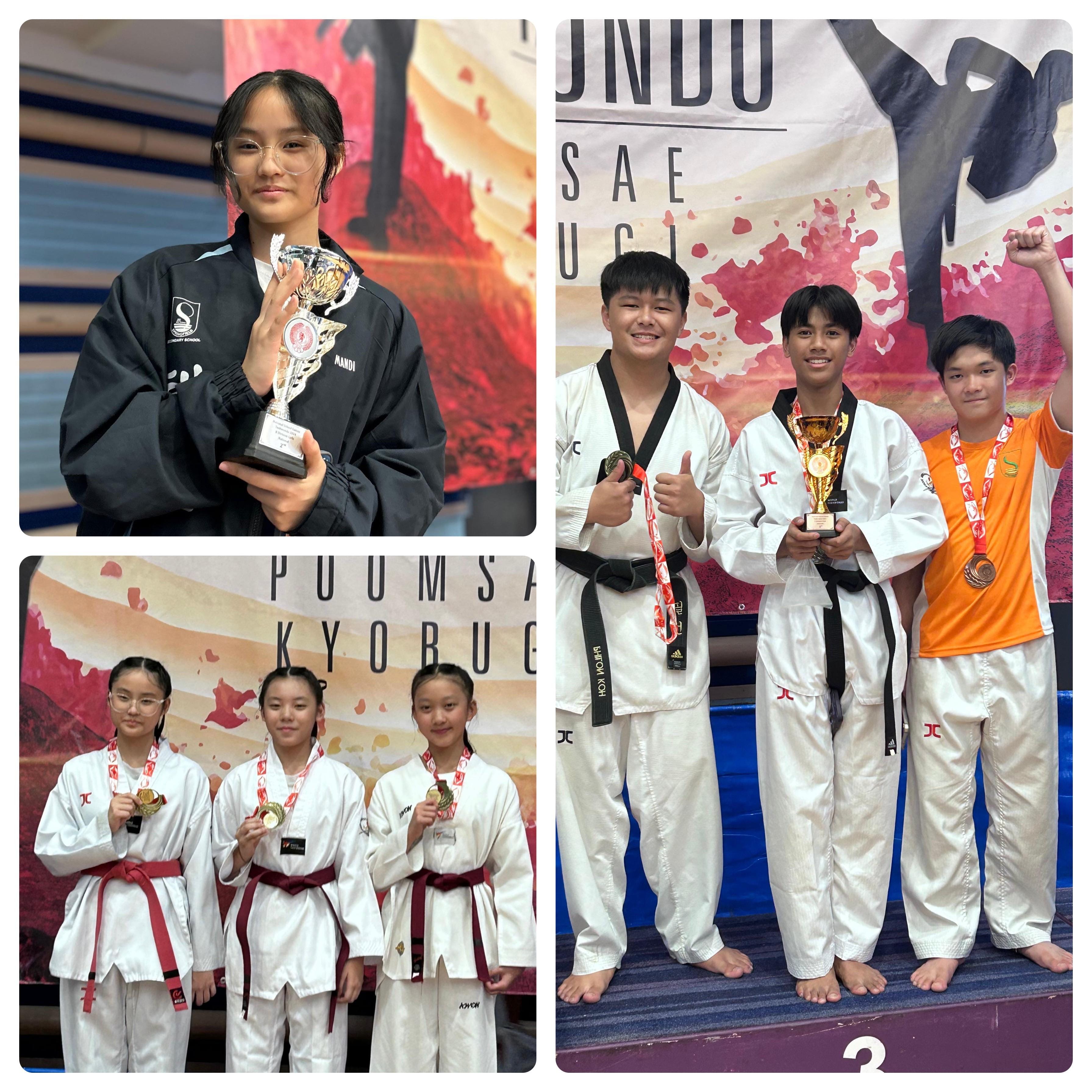 Six taekwondo competitors in uniforms pose with trophies and medals at a Poomsae Kyorugi tournament.