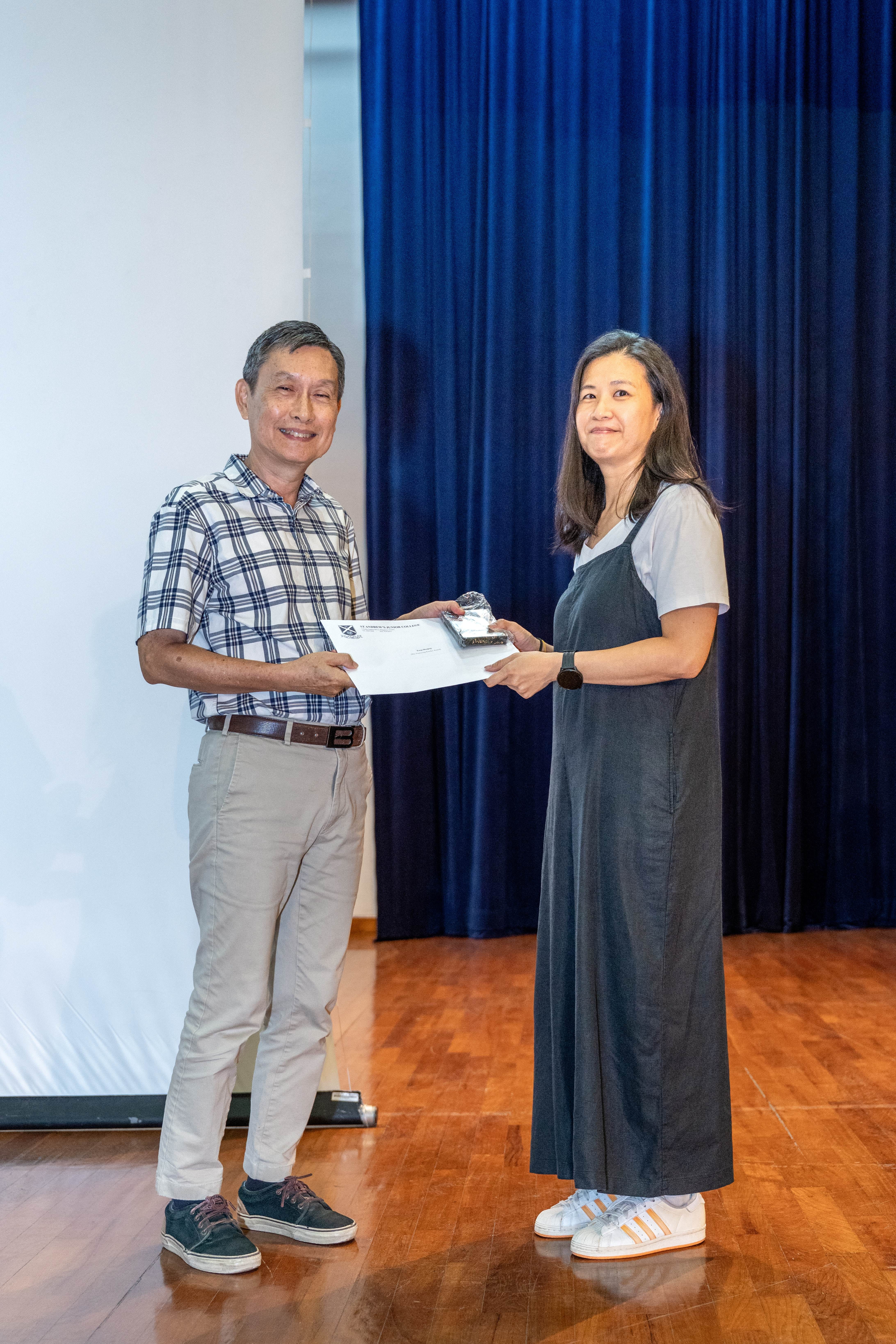 Ms Tong Shuqing receiving her award from Deputy Principal of SAJC, Mr Ang Kheng San Cecil