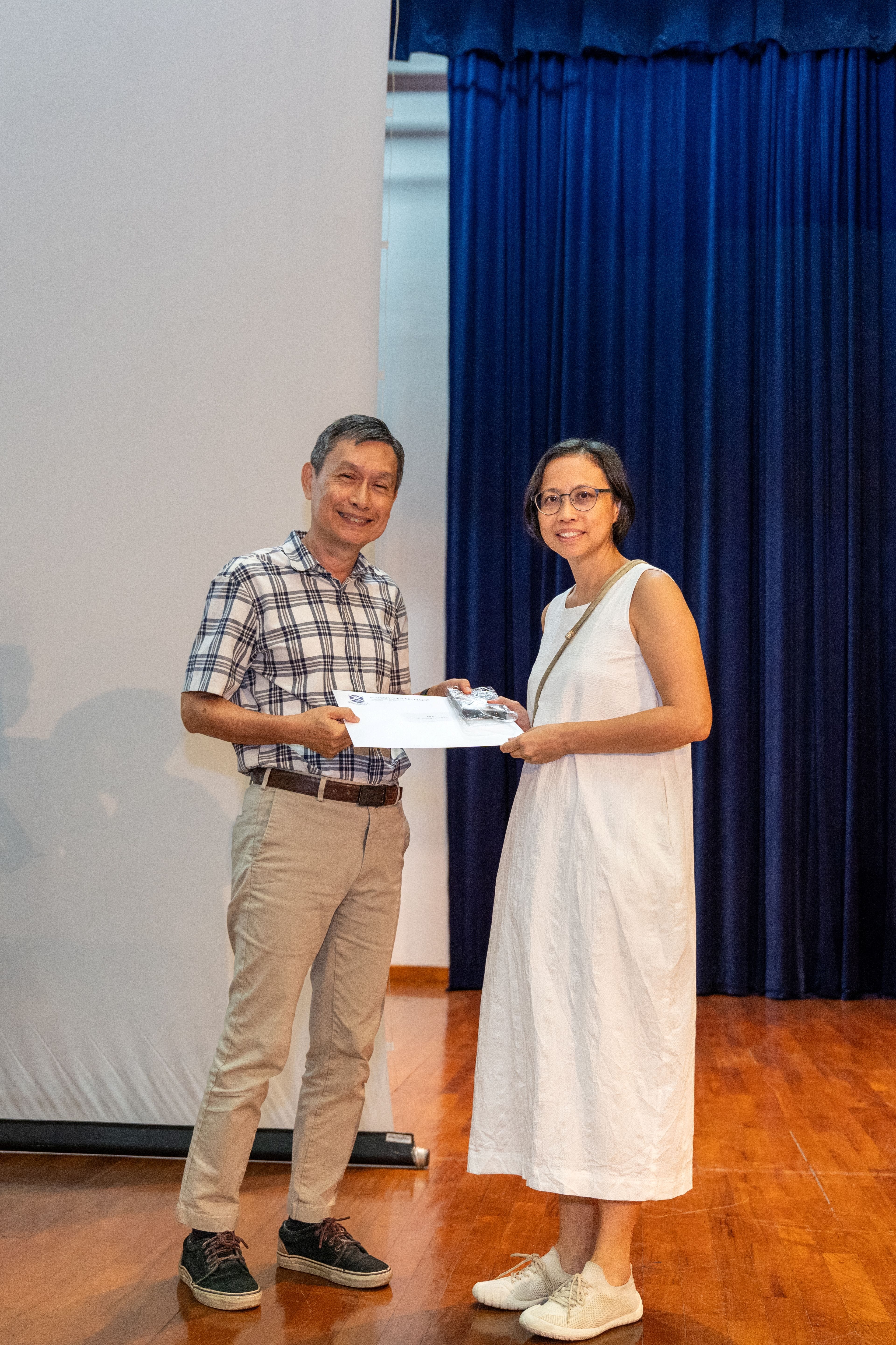 Ms Tan Joy receiving her award from Deputy Principal of SAJC, Mr Ang Kheng San Cecil