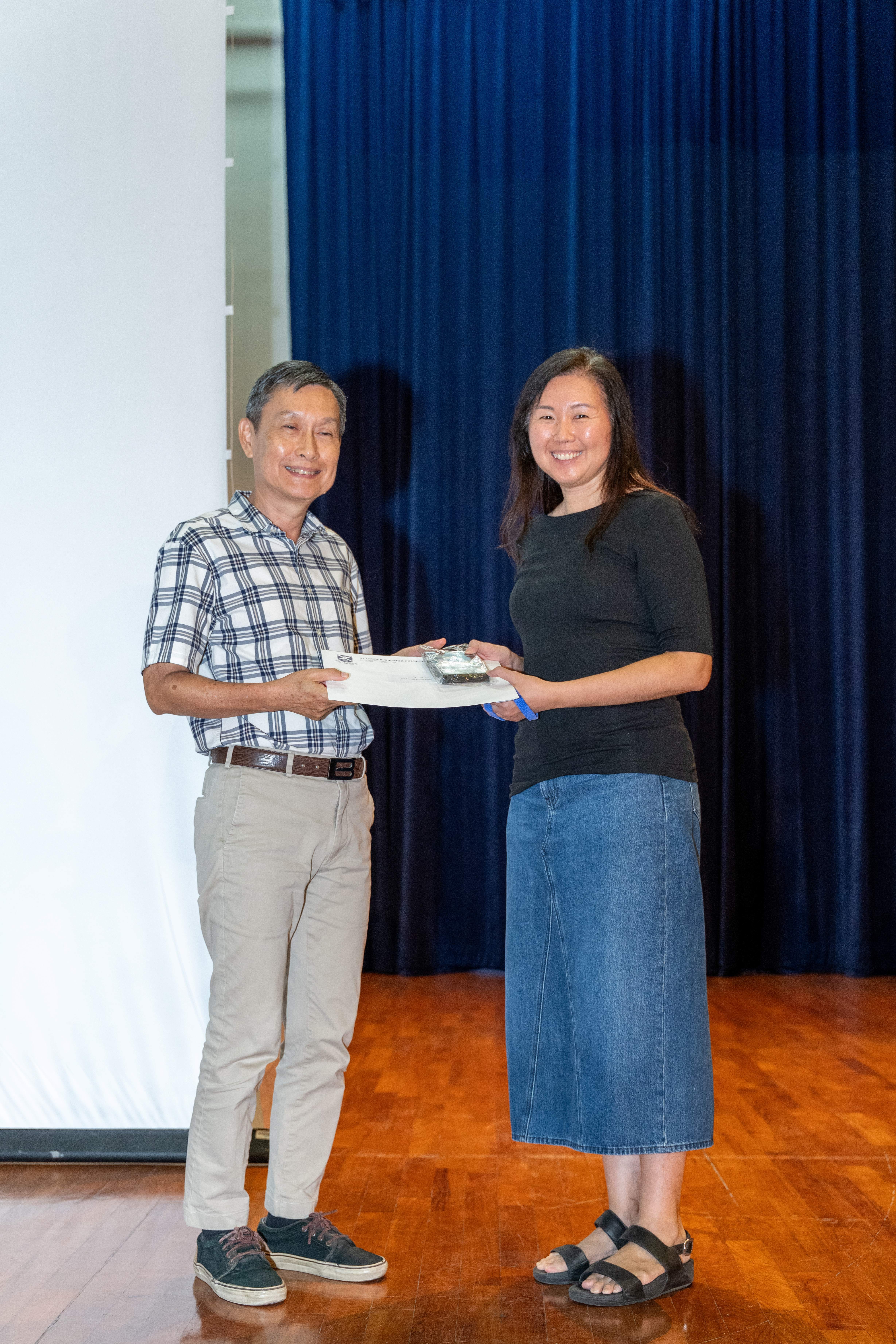 Ms Regina Chan receiving her award from Deputy Principal of SAJC, Mr Ang Kheng San Cecil