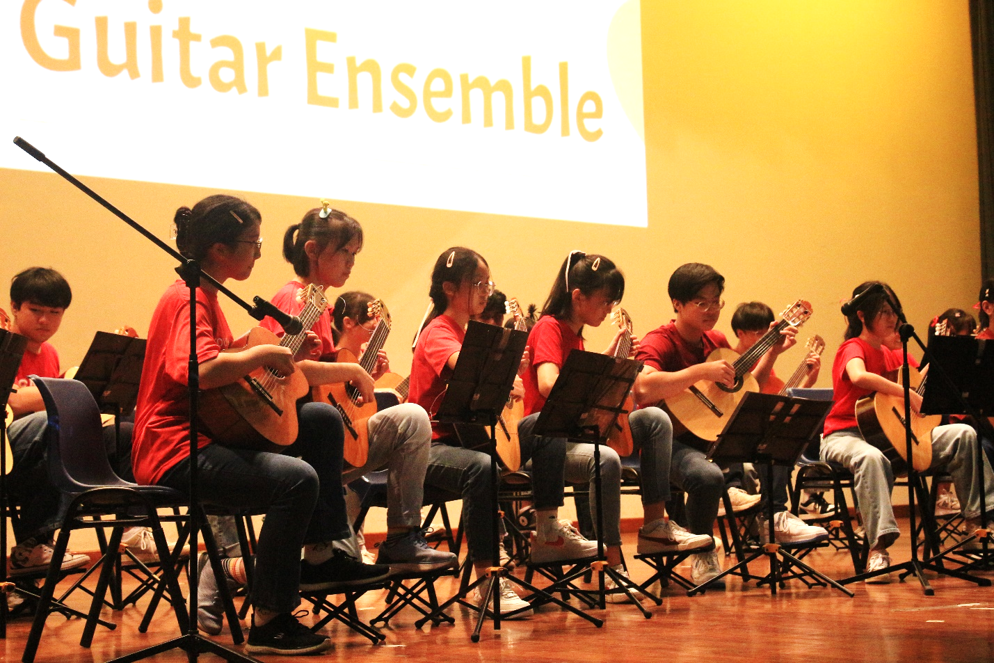 The Guitar Ensemble performing on stage at the College's Cultural Centre.