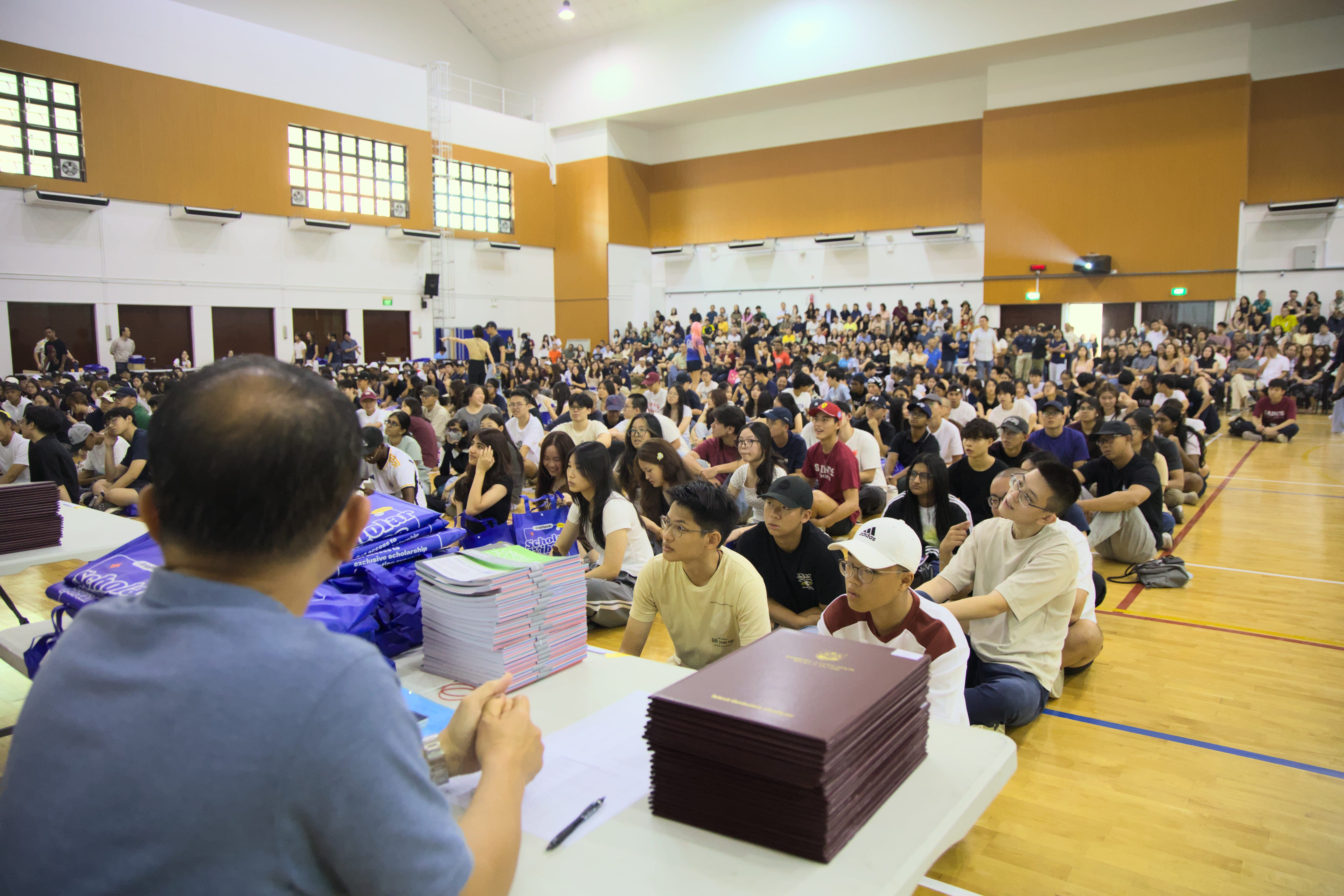 Image of Saints alumnus sitting in the hall awaiting the collection of the A Level Results.