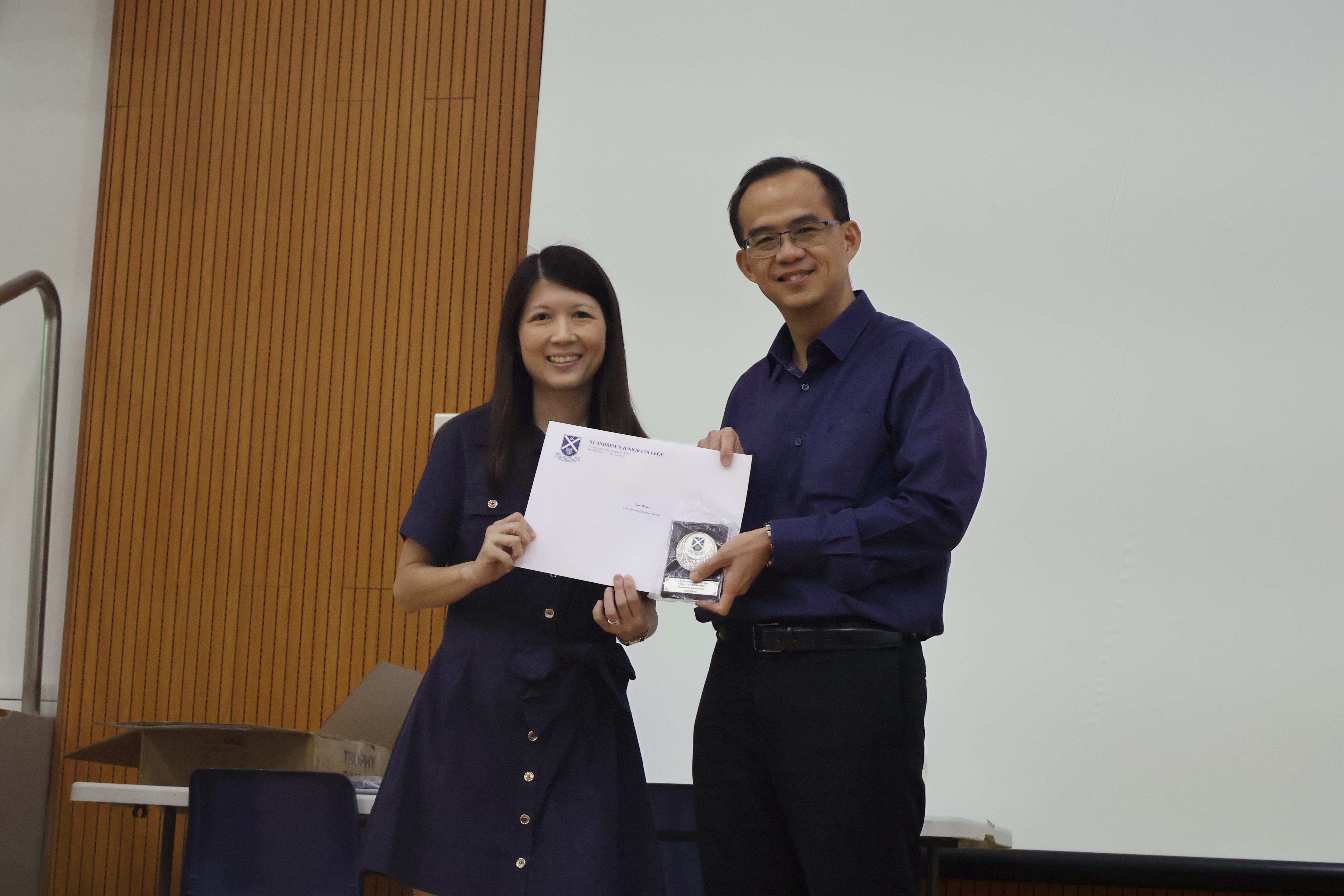 Ms Low Wanyi receiving her award from Principal of SAJC, Mr Tham Kine Thong