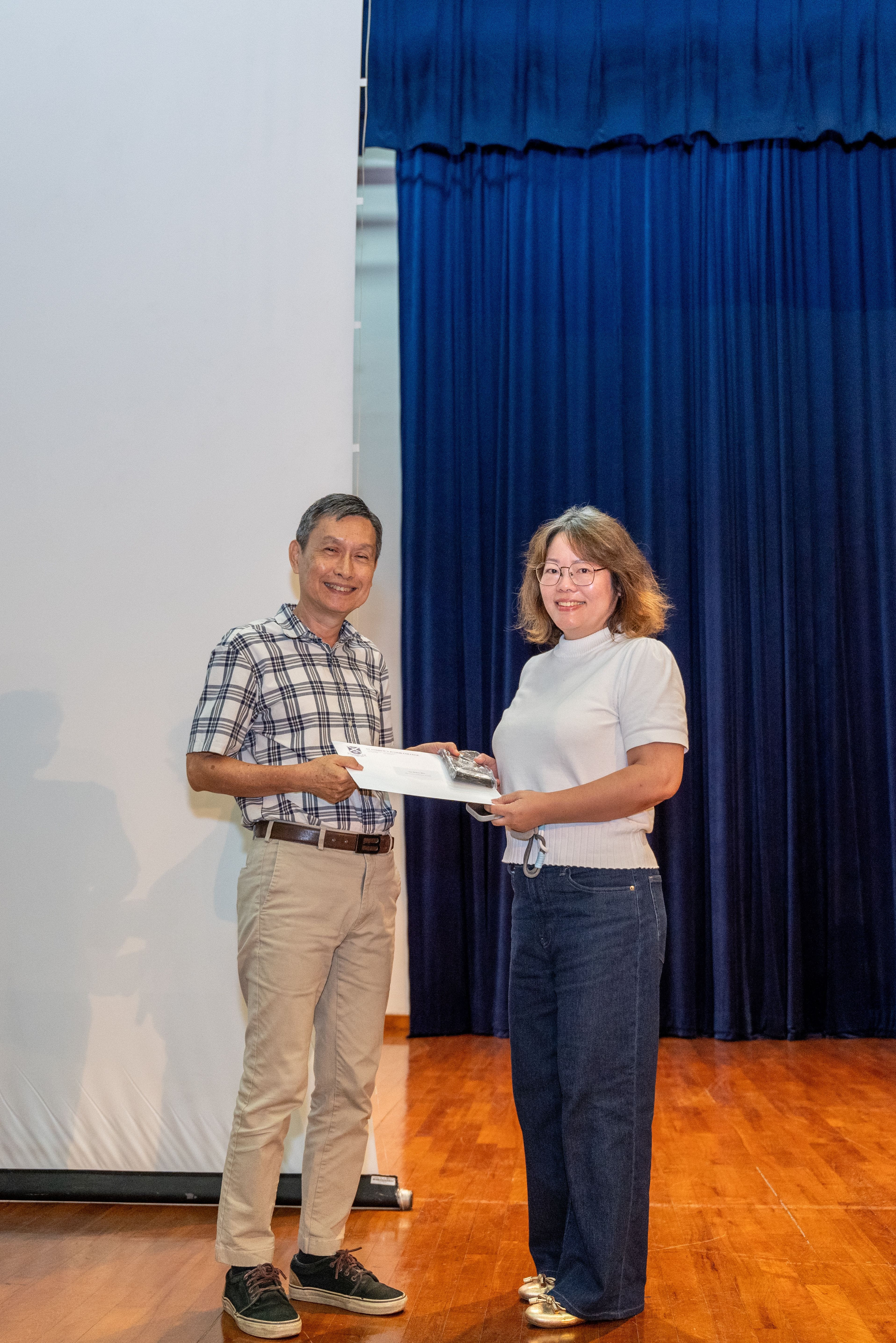 Ms Tan Meileen Bliss receiving her award from Deputy Principal of SAJC, Mr Ang Kheng San Cecil
