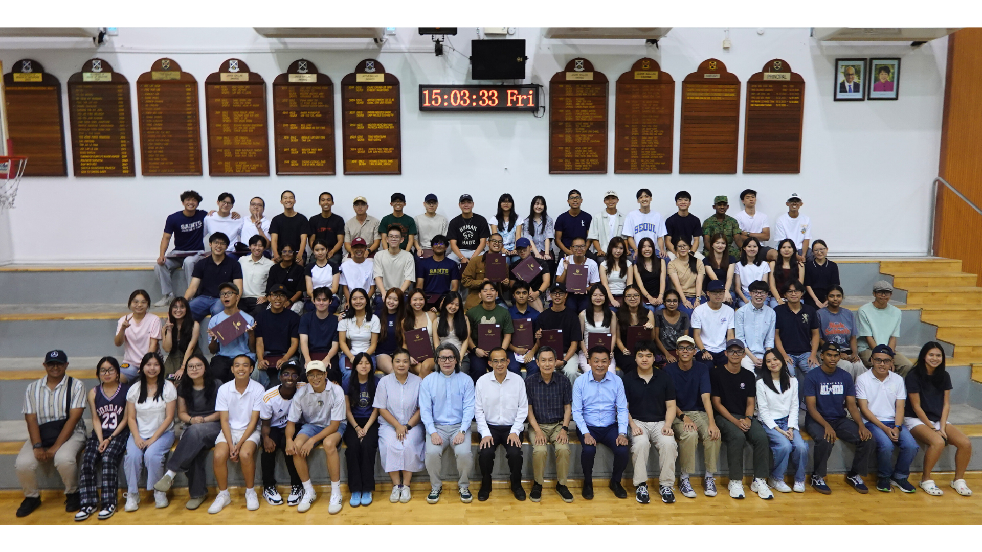 Class of 2025's top performers posing for a group shot on the galleries of the school hall with our School Leaders and Reverend David Lee from the Chapel of the Resurrection..