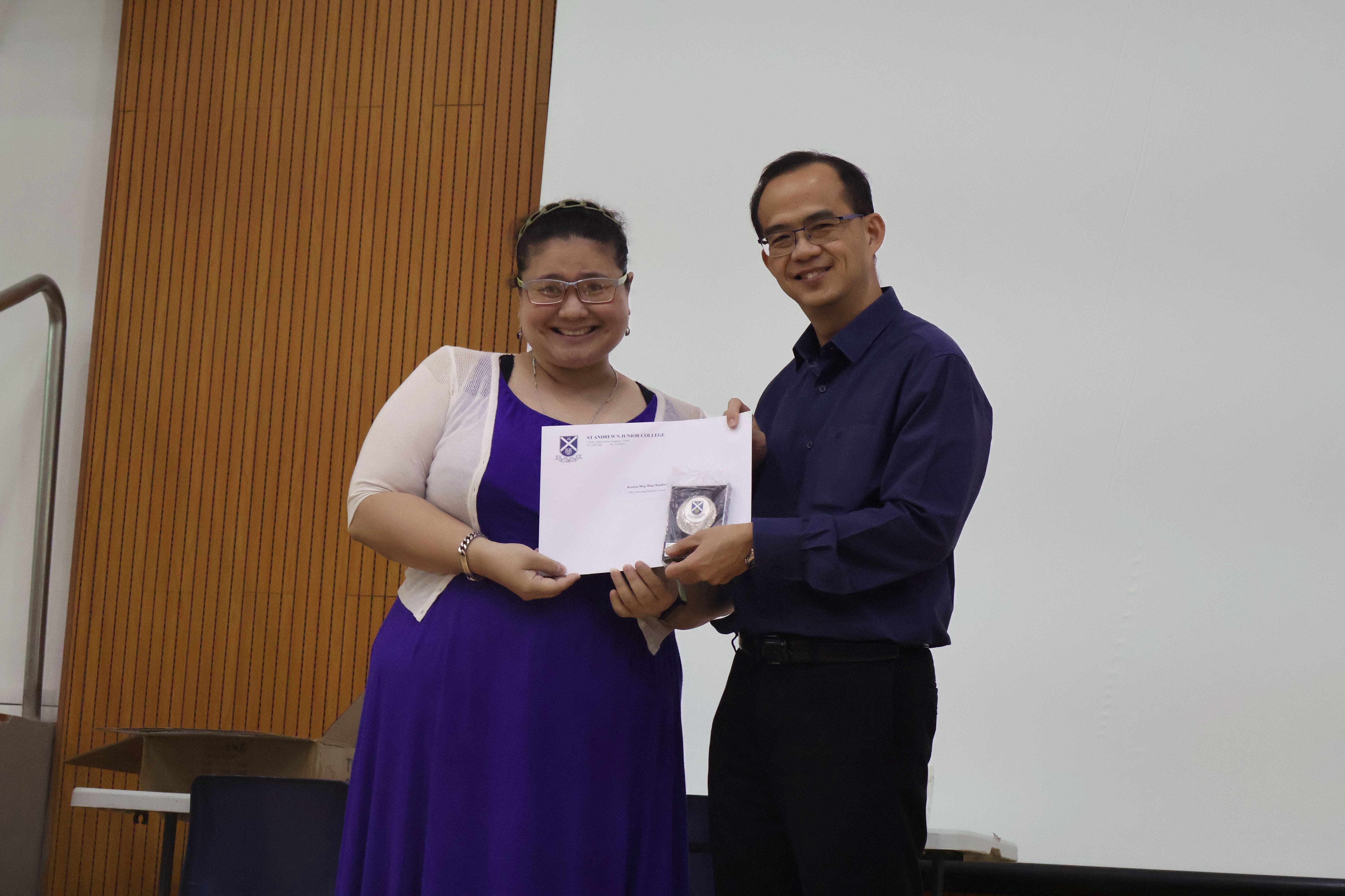 Ms Kristina Chandran receiving her award from Principal of SAJC, Mr Tham Kine Thong