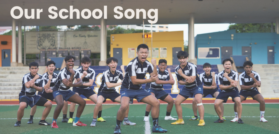A group of male students in navy blue rugby jerseys perform a haka on a sports field, with the central player leading the pose with fists raised and knees bent. The image is overlaid with the text 'Our School Song' in bold white font.