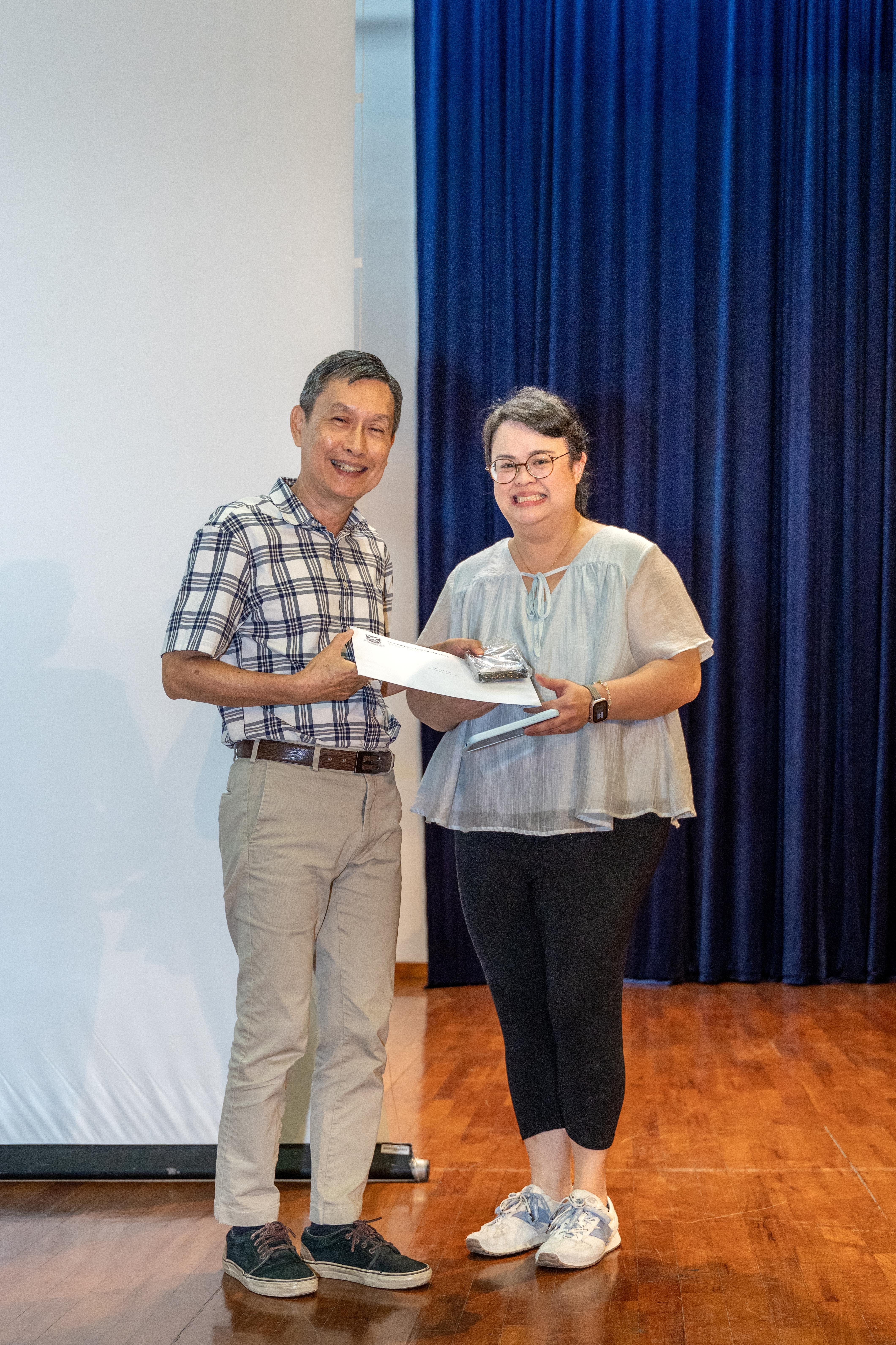 Ms Teo Yue Qi Astor receiving her award from Deputy Principal of SAJC, Mr Ang Kheng San Cecil