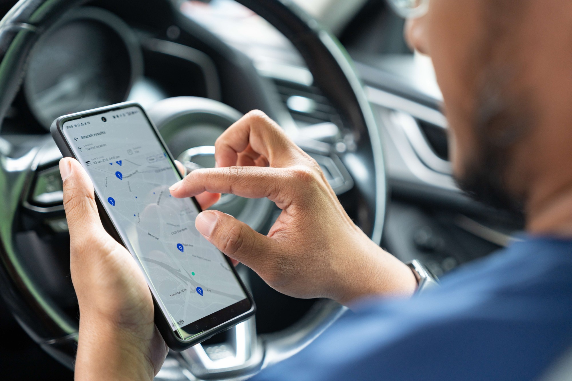 Malik in his car demonstrating the GetGo app