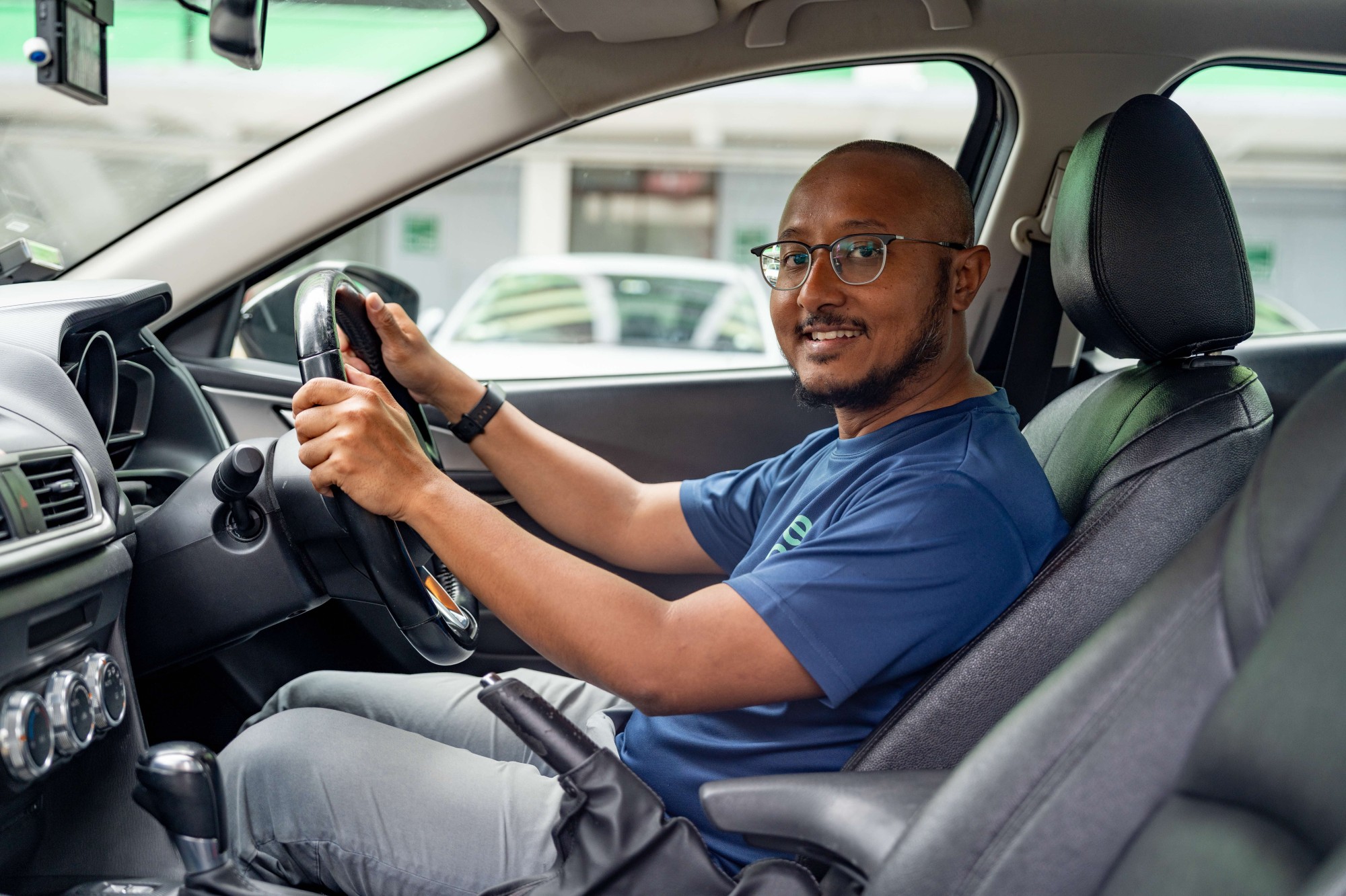 Malik driving a car