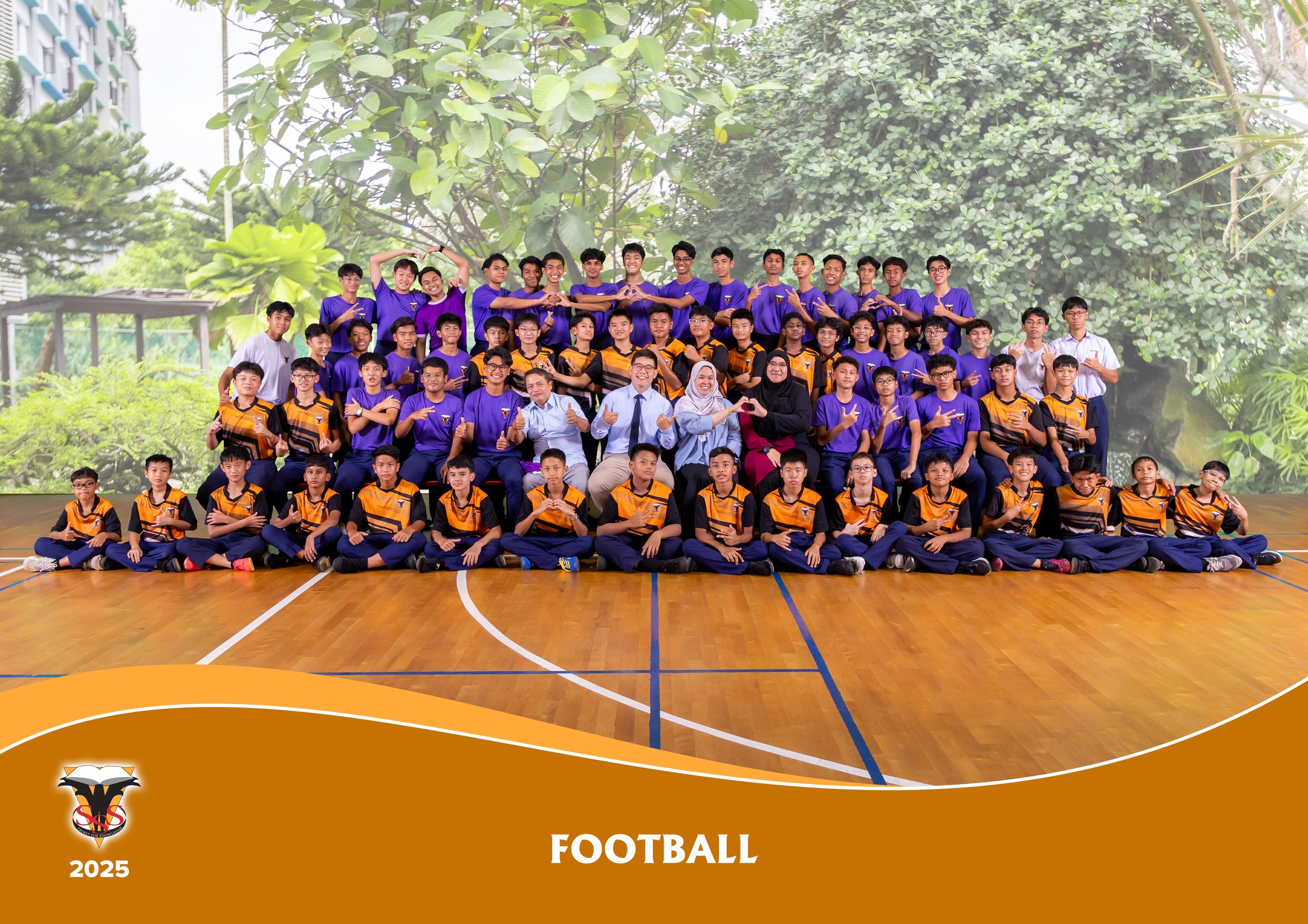 Large school football team group photo on a wooden court, boys in purple and orange uniforms with coaches, labeled Football 2025.