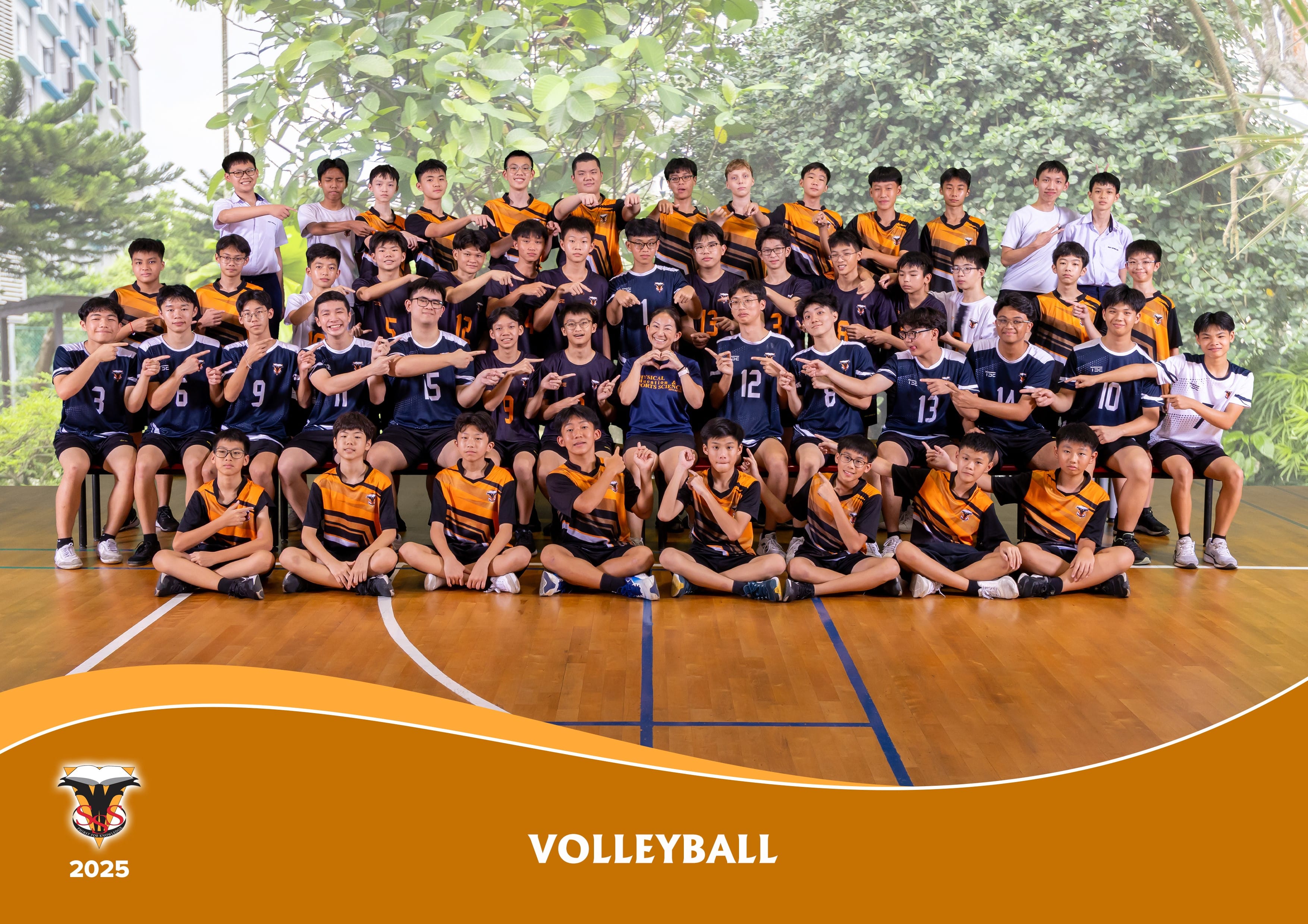 A school volleyball team group photo from 2025, with boys in navy and orange jerseys posing on an indoor court.