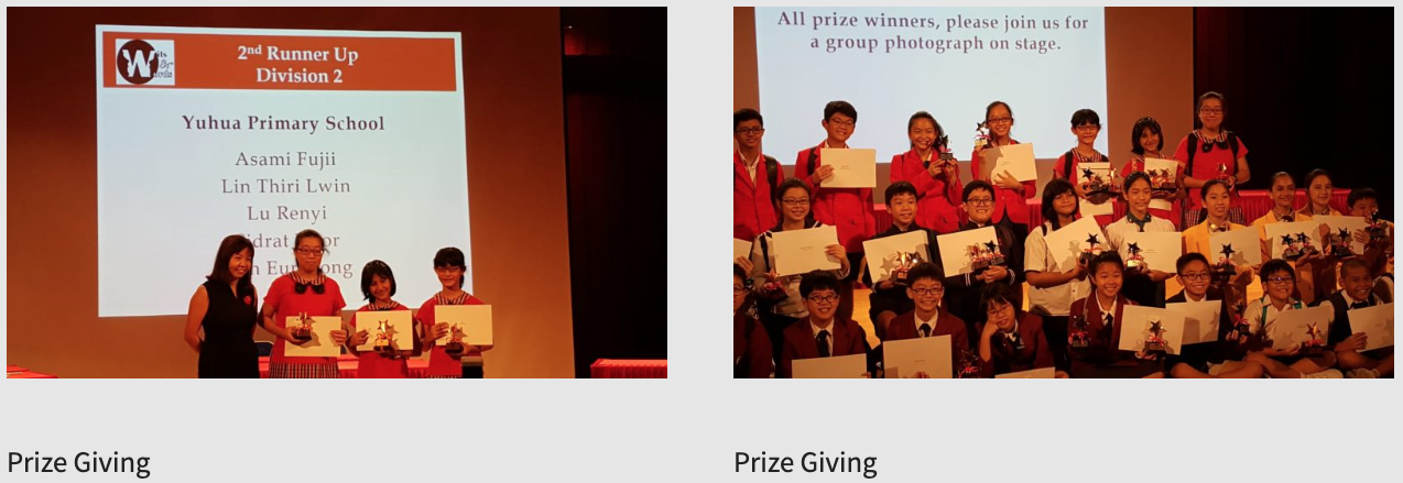 Students holding certificates and trophies on stage during a prize giving ceremony, with a projection screen behind them.
