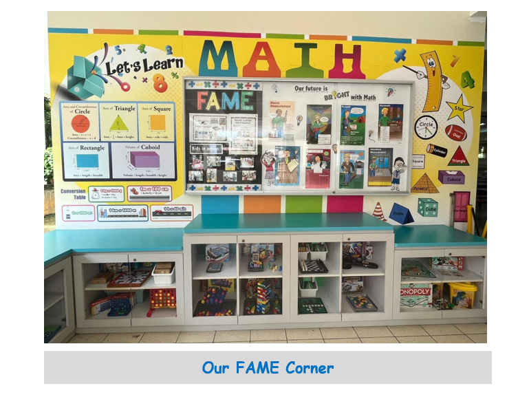 Colorful classroom math corner with a bright bulletin board, shape posters, and shelves holding board games and toys.