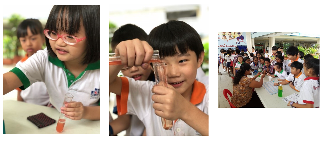 Young children in school uniforms conduct science experiments, pouring pink liquid into test tubes outdoors.