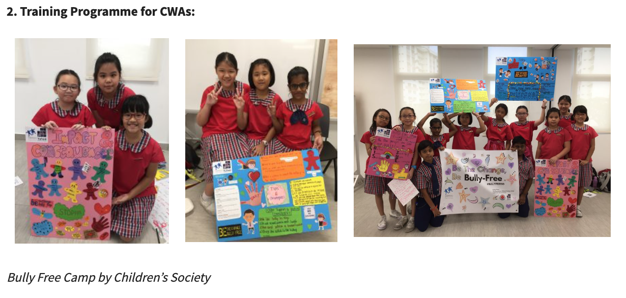 Students in red uniforms hold colorful anti-bullying posters at a Bully Free Camp by Children's Society.