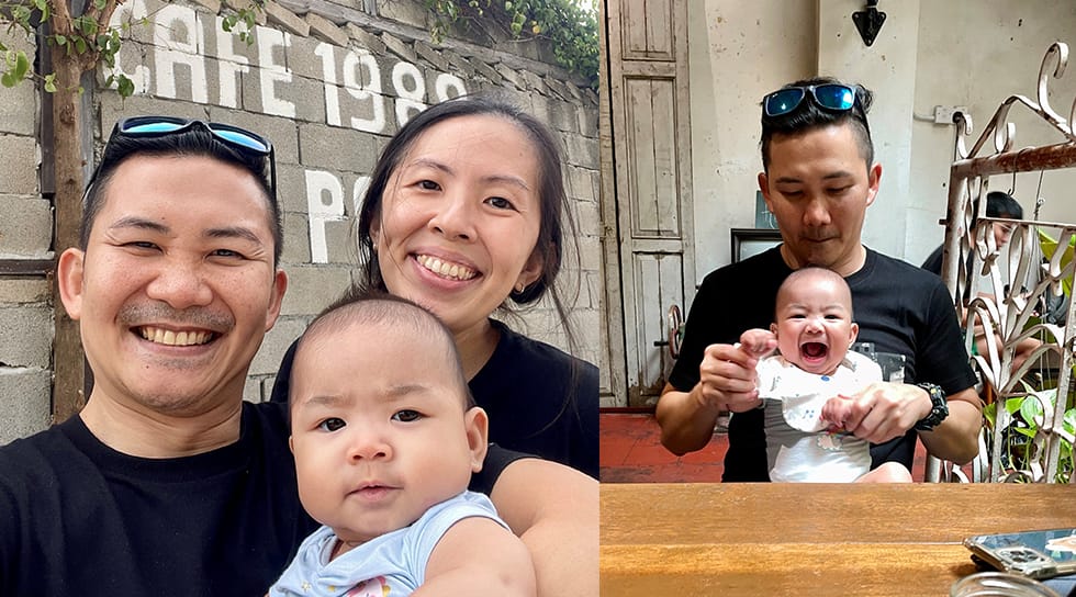 Parents with their baby at an outdoor café, including a father playing with the child