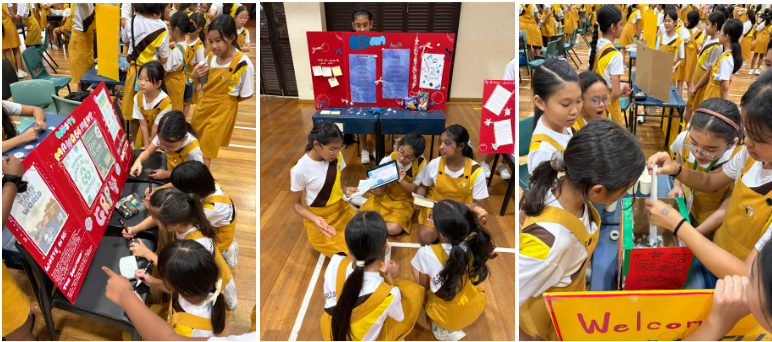 Students in yellow uniforms gather around project display boards during a school science or project fair.