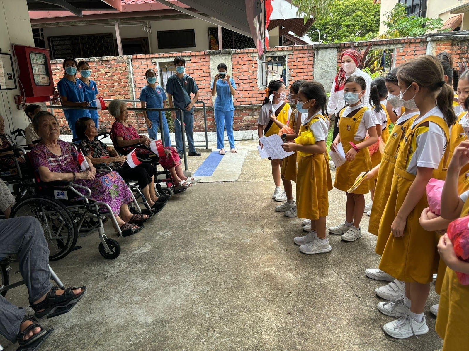 Students spread joy with National Day bags at Serene Nursing Home.