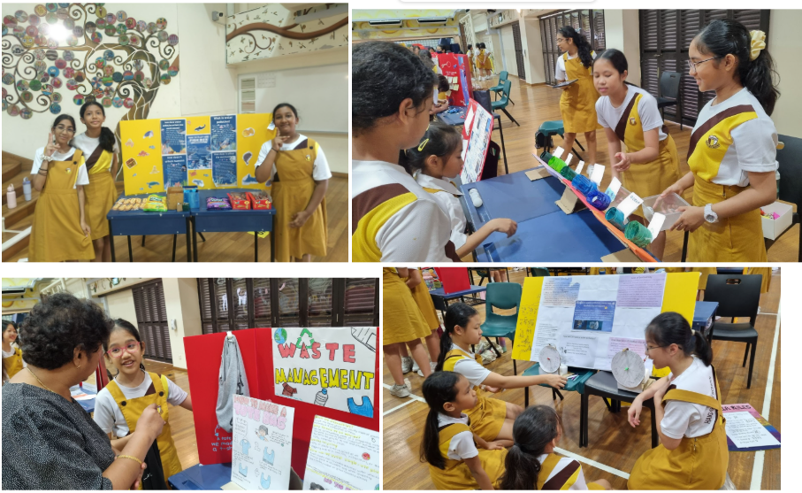 Students in yellow uniforms present school project boards on waste management at an indoor science fair.