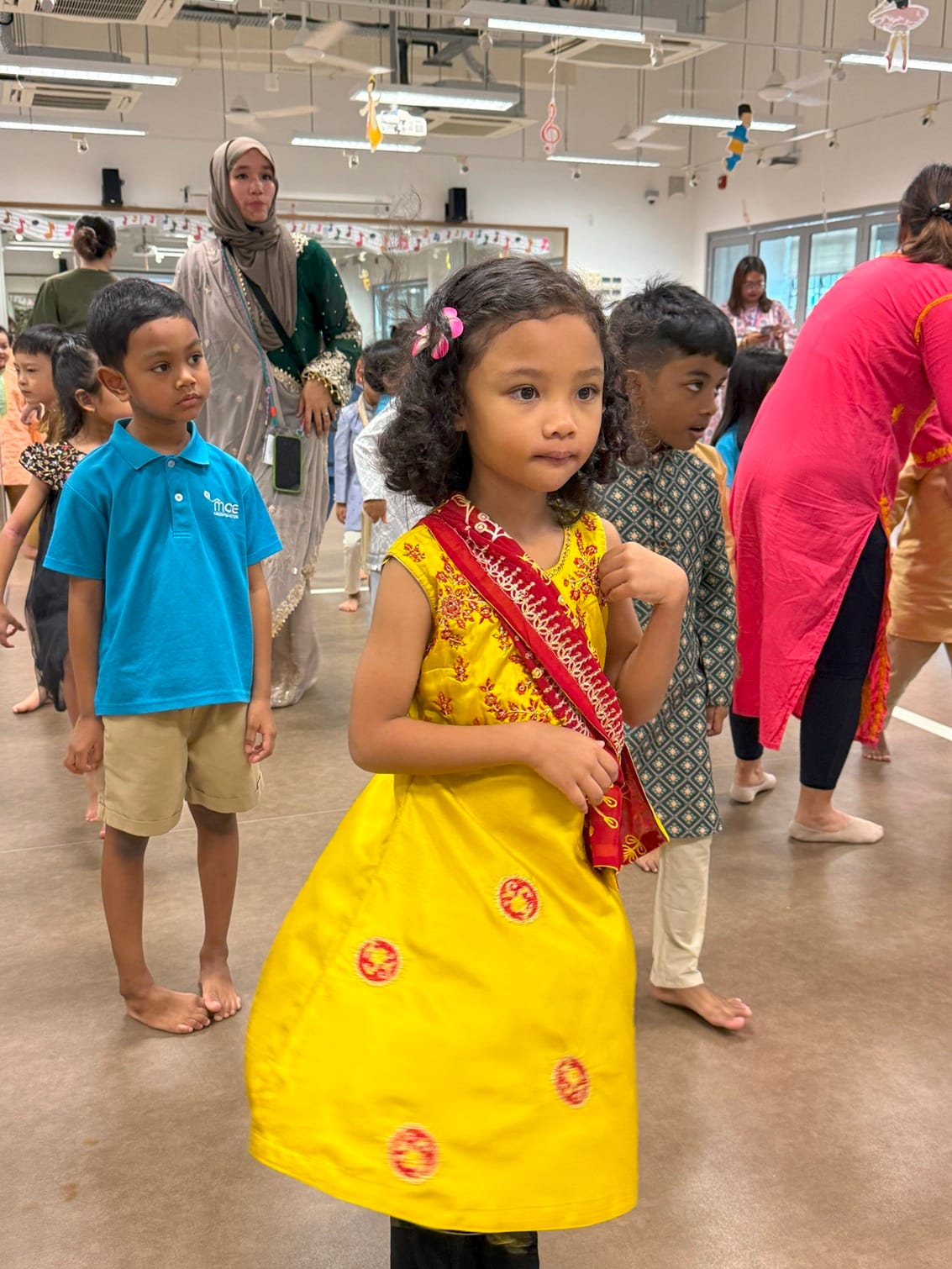 Children began the day with an energetic Indian dance segment, moving to lively music while learning simple hand gestures and rhythms. Laughter and excitement filled the hall as friends, teachers, and families clapped along.