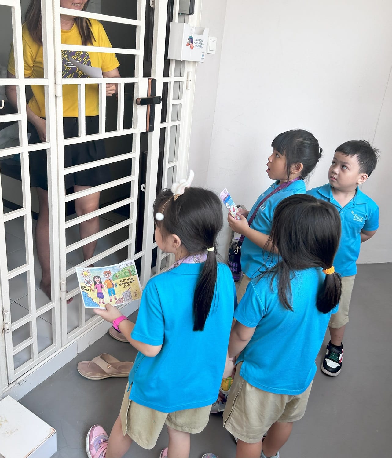Building on their newfound understanding, the children created Stamp Out Dengue posters to remind the community to take an active role in preventing mosquito breeding. Selected posters were printed as leaflets, and the children, accompanied by their parents and teachers, distributed them throughout the neighborhood. They reached out to the community by delivering leaflets to homes and public spaces such as coffee shops and provision stores.