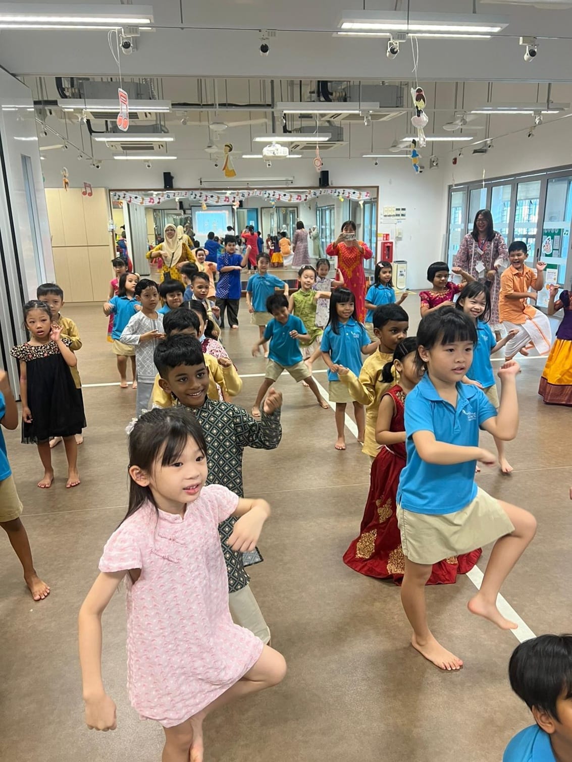 Children began the day with an energetic Indian dance segment, moving to lively music while learning simple hand gestures and rhythms. Laughter and excitement filled the hall as friends, teachers, and families clapped along.