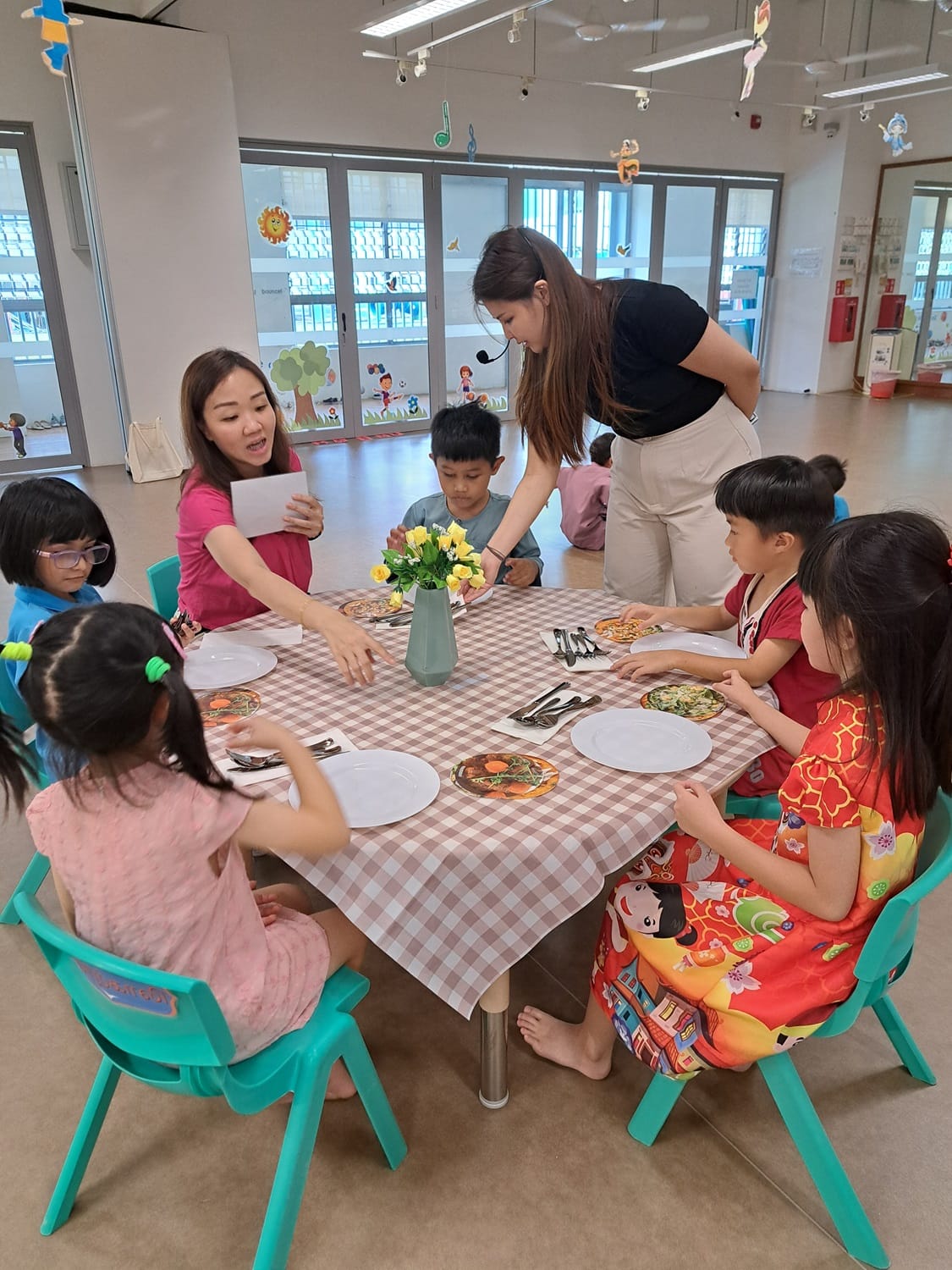 Children enjoying a 5-course dinner with proper etiquette.