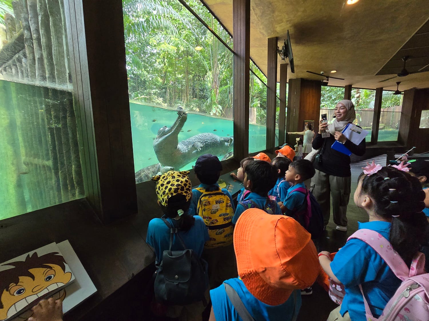 The children walked along the reptiles section and greeted the crocodiles there.