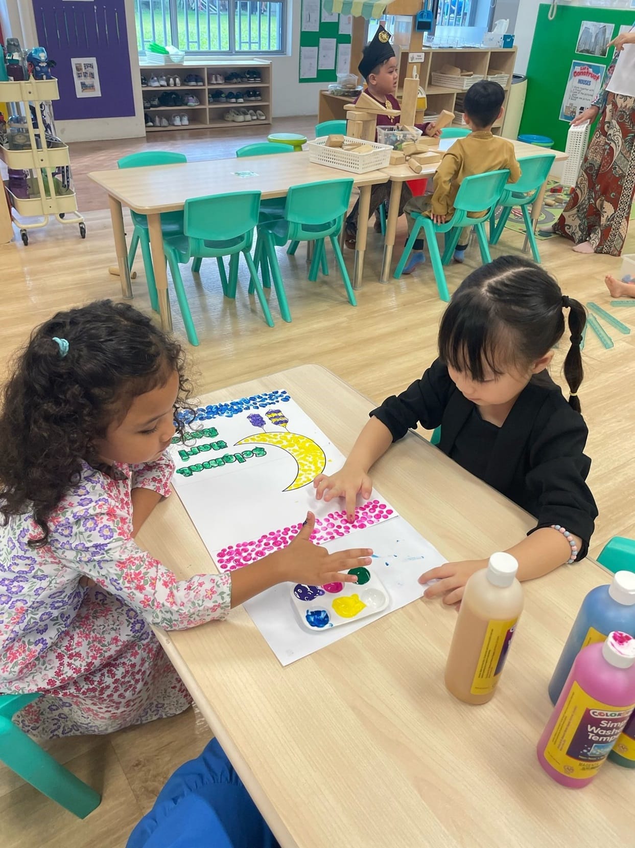 To promote the spirit of giving on this special event, the children decorated Hari Raya cards with various art materials like paints. They worked together as a class to design these masterpieces!