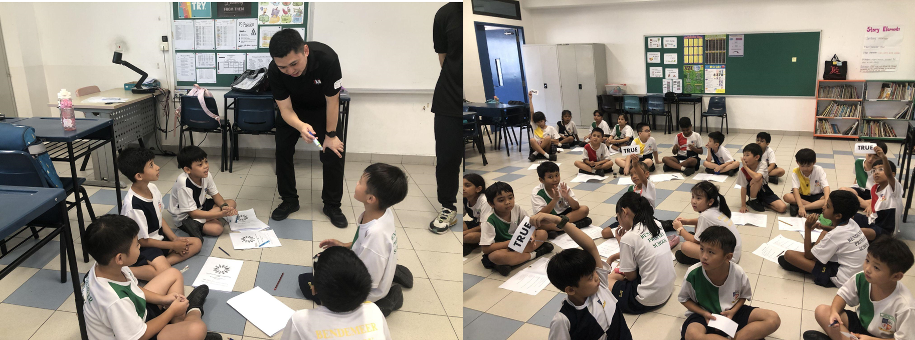 Young school children sit on a classroom floor during a lesson, with an adult instructor leaning toward them holding a marker.