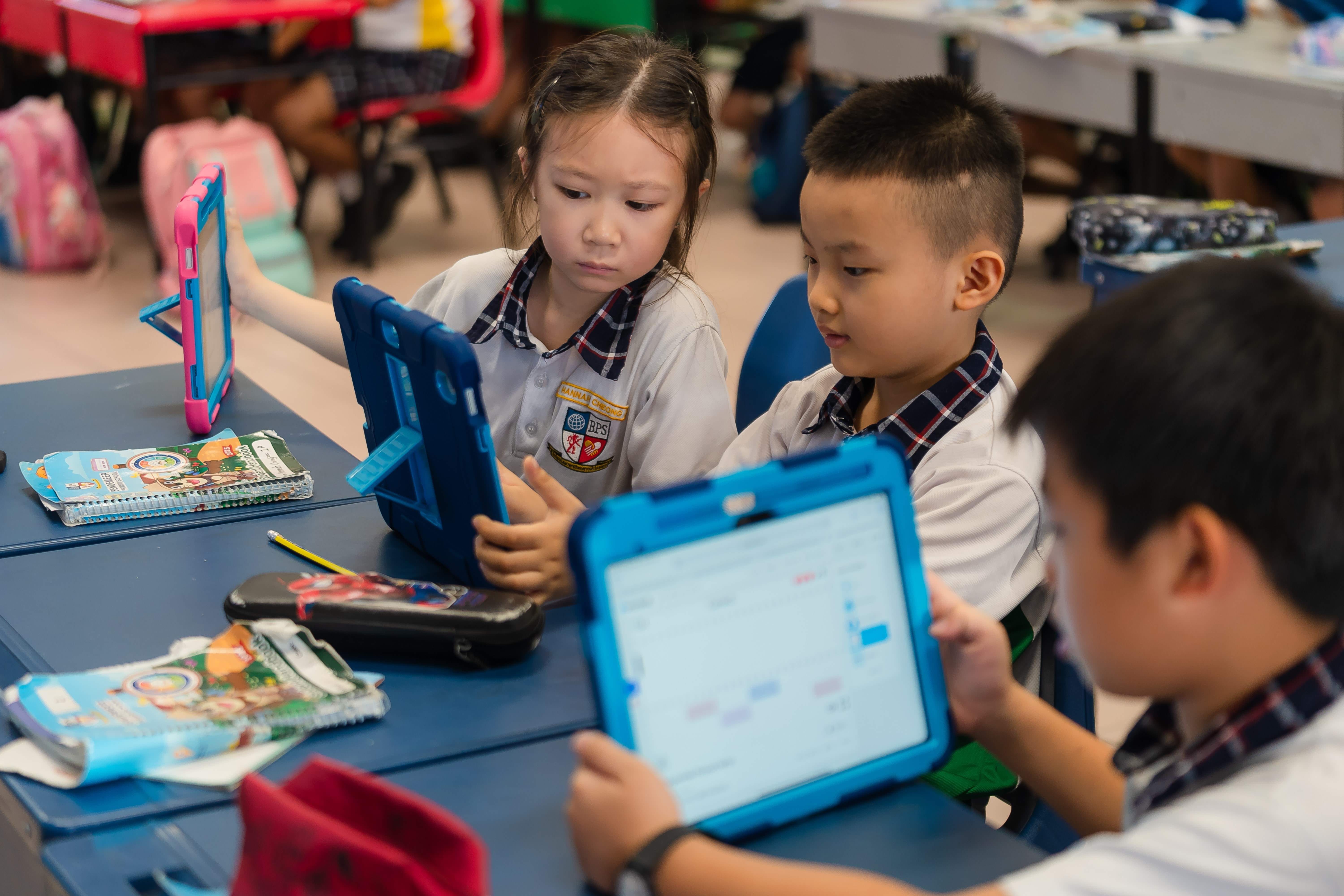 Students using iPads for online class activities