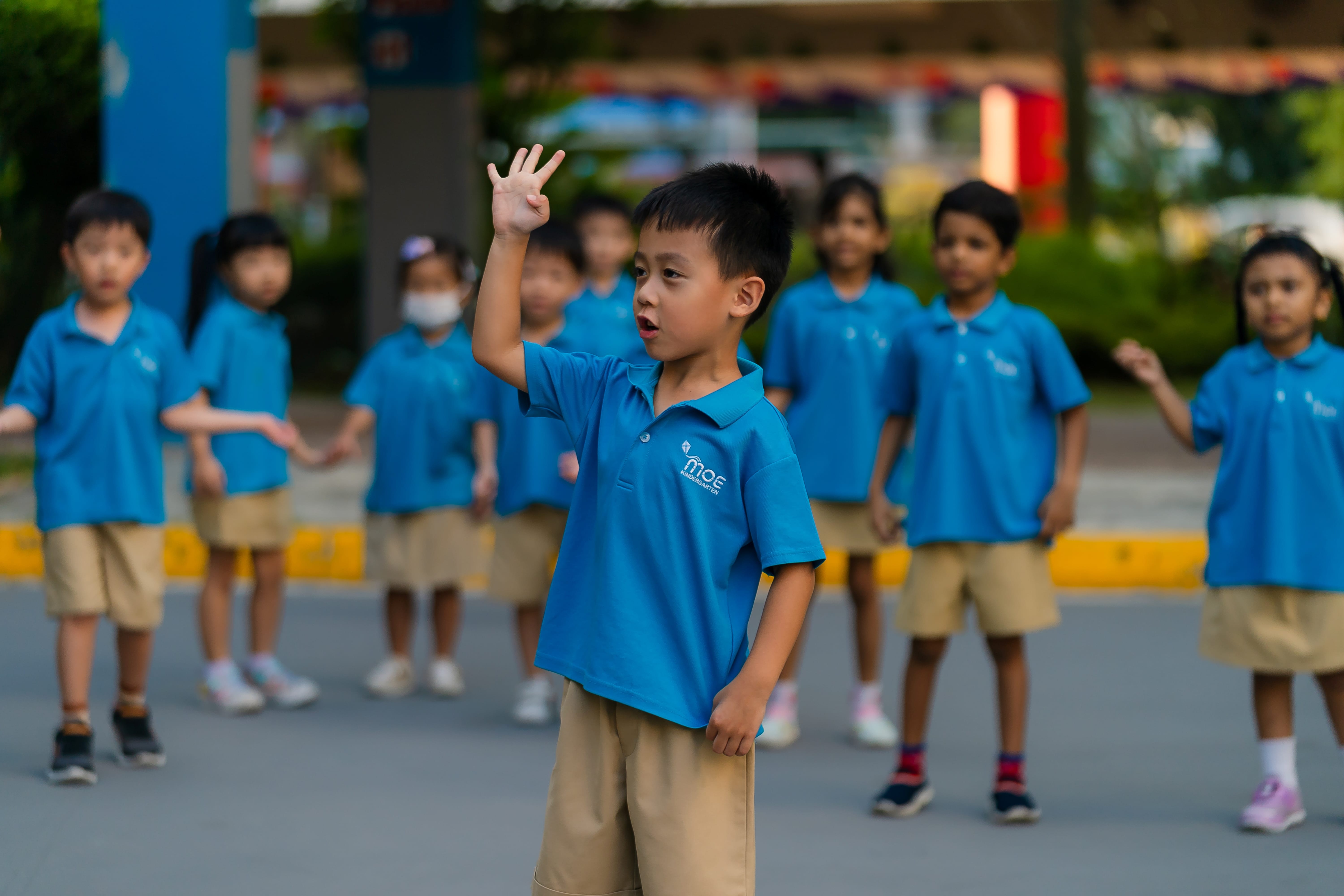 A preschooler in the foreground with other children behind him