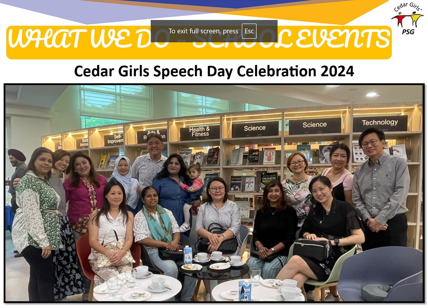 A group of adults posing together in a library at Cedar Girls Speech Day Celebration 2024.