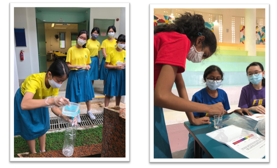 Students wearing masks do science activities: one pours liquid into a bottle while others observe, and two review papers.