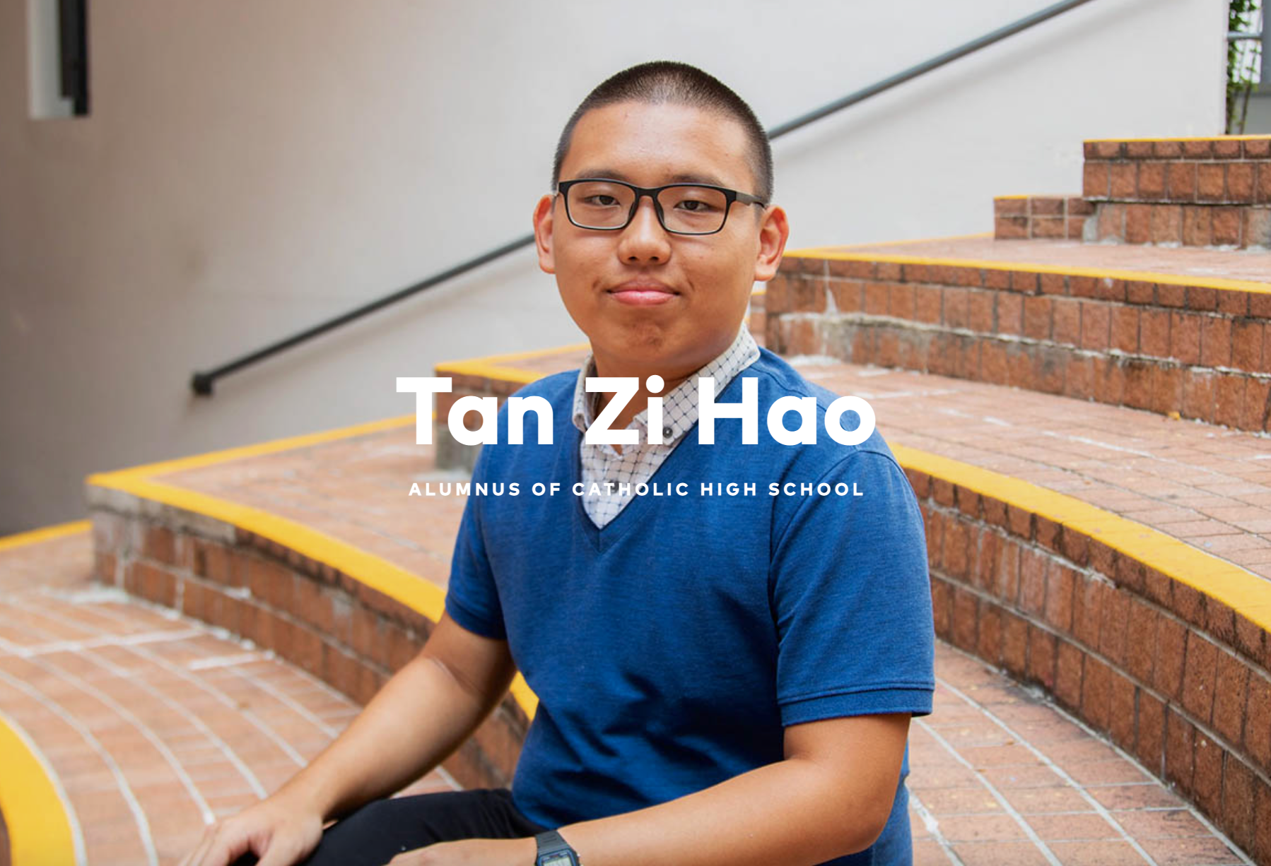 Young man with glasses in a blue shirt sits on brick steps, labeled Tan Zi Hao, Alumnus of Catholic High School.