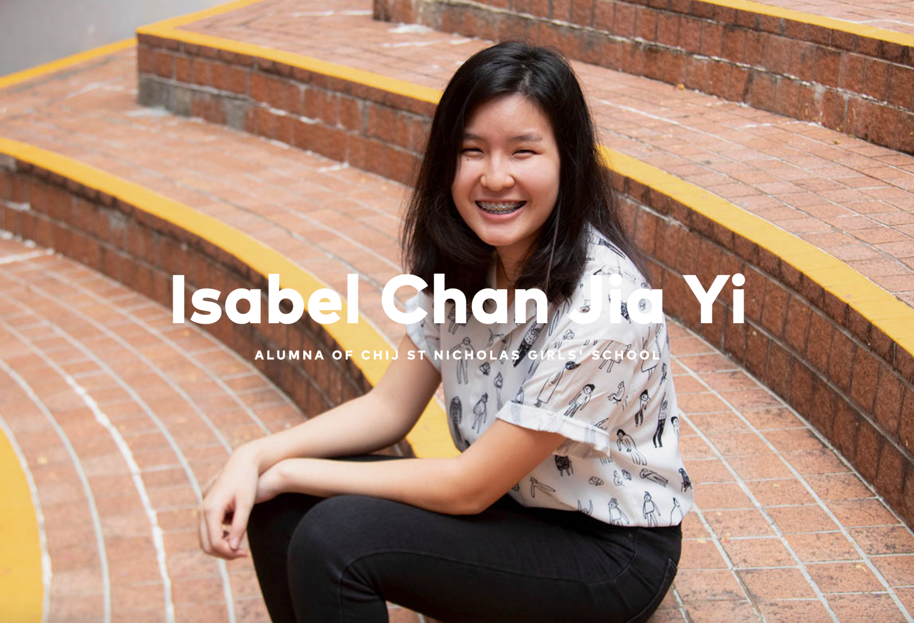 Young woman with braces smiling while sitting on brick steps with yellow edges, labeled Isabel Chan Jia Yi.